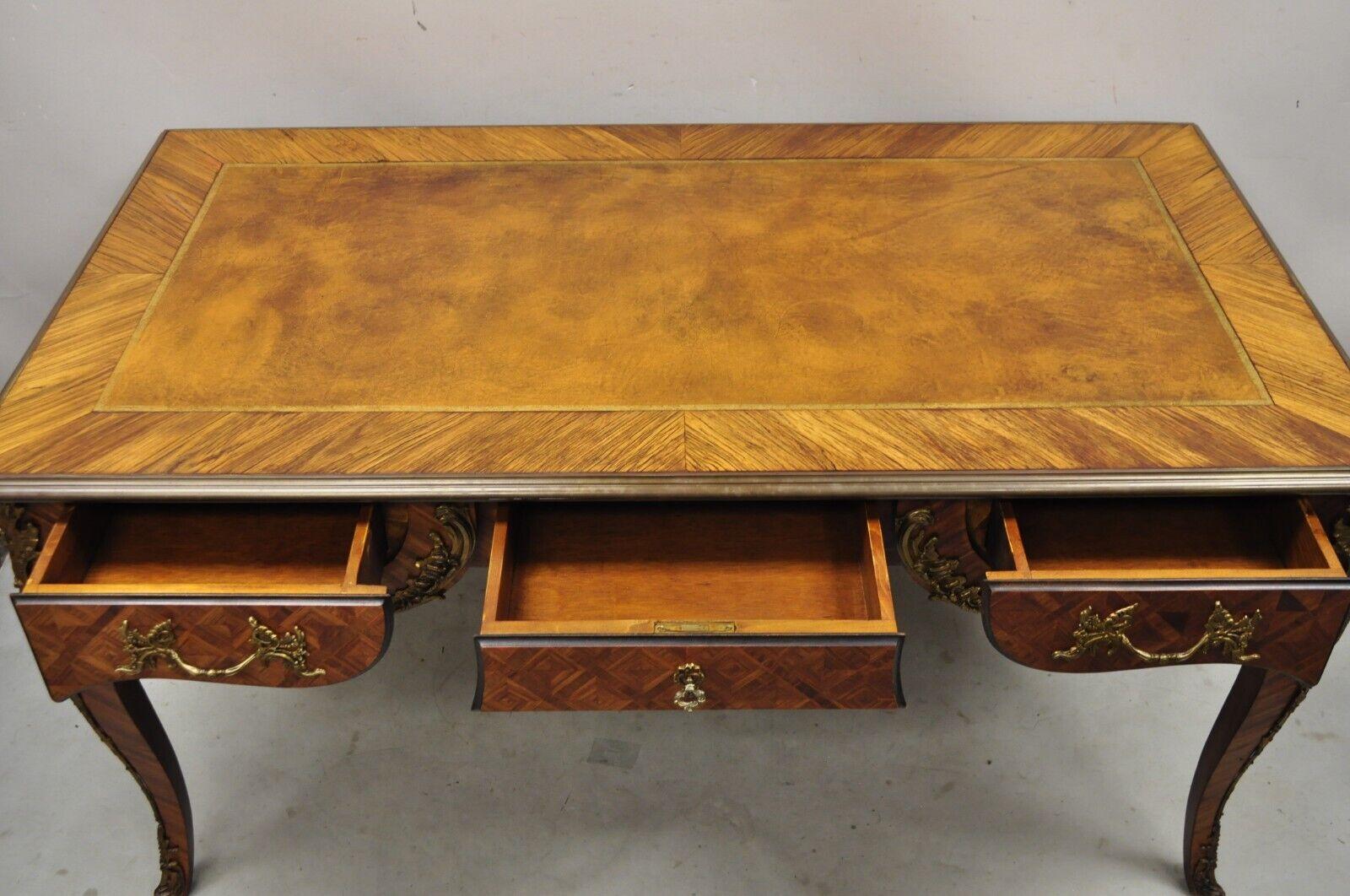 French Louis XV Style Italian Bronze Figural Ormolu Brown Leather Top Desk Bureau Plat. Item features ornate bronze figural ormolu, finished back with bronze face and parquetry inlay (see pic 10). Brown tooled leather top, bronze edge trim to top.