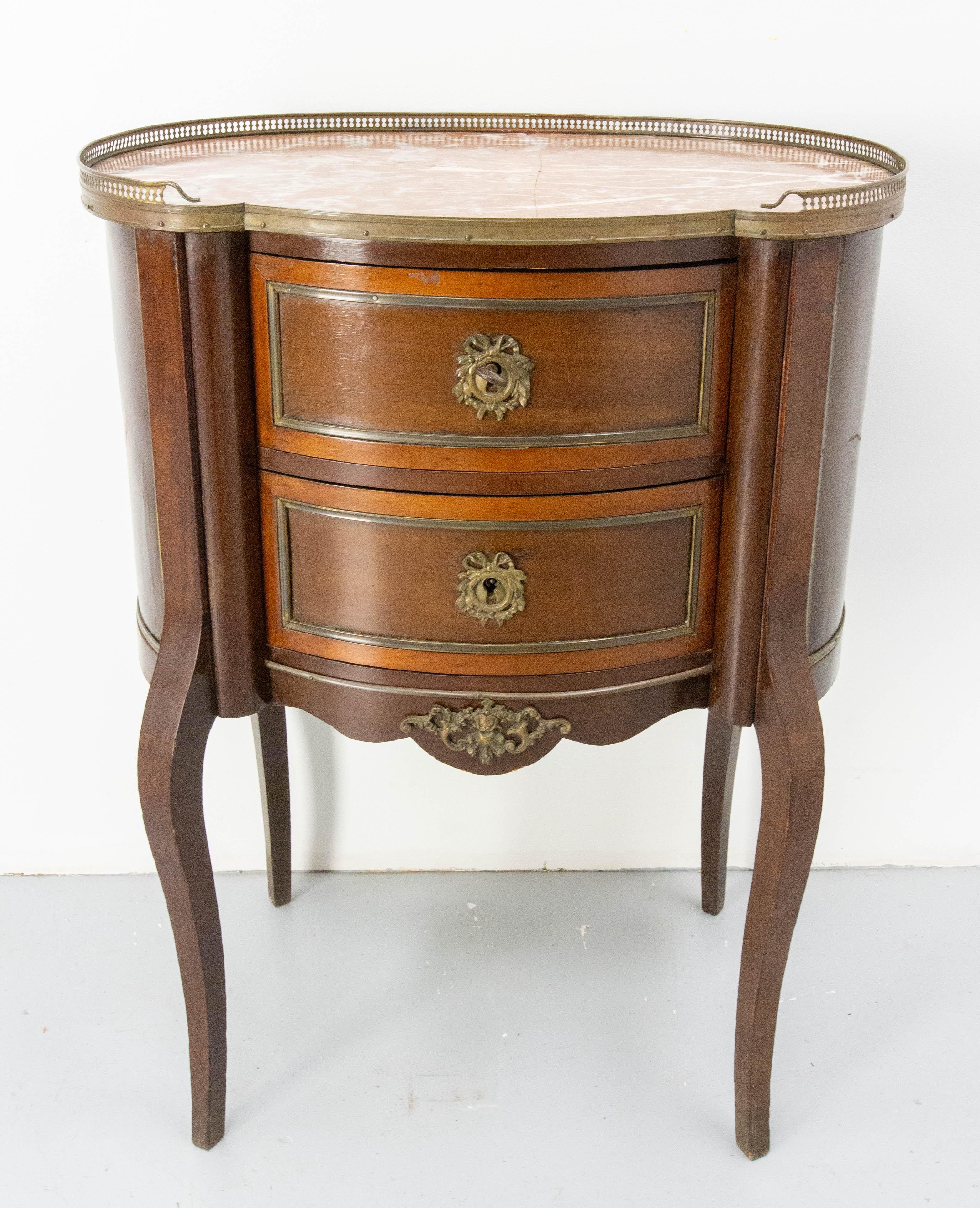 Antique commode in the Louis XV style, French chest of drawers, circa 1960. Iroko, marble top and brass.
The kidney shape of tops on the furnitures is typical of the 18th century. It is found in the Louis XV style with curved legs and in the Louis