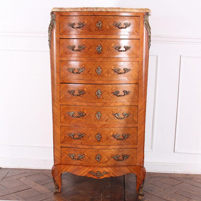 A pretty French seven-drawer chest or ‘semainier’ in kingwood and featuring floral inlay and marquetry to the sides and drawer fronts. Fine ormolu mounts and the original shaped marble top.