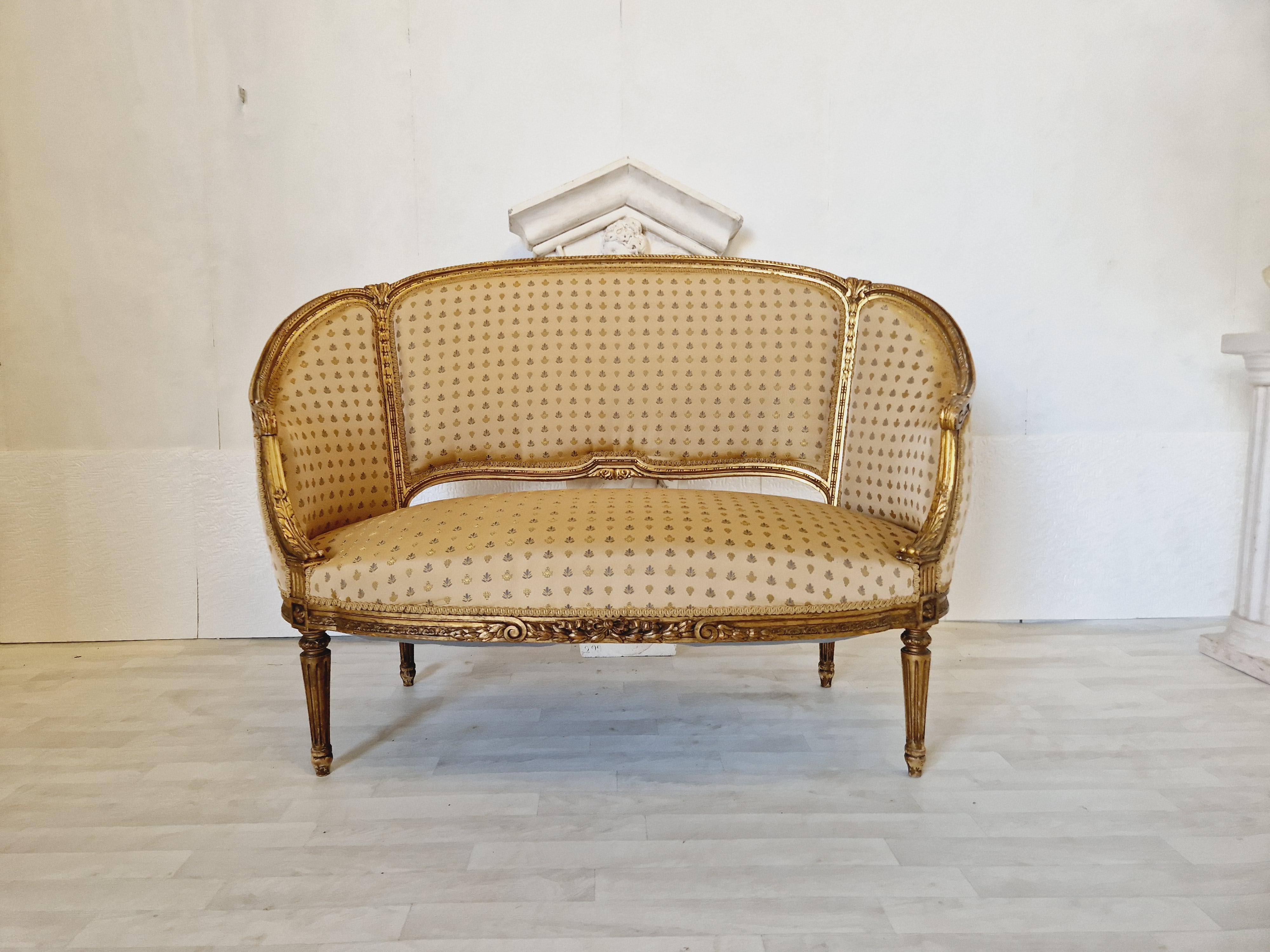 This elegant living room set from the 19th century features a glamorous Louis XV style with intricate Rocaille branding on giltwood frames. The set includes a sofa and chairs upholstered in luxurious silk, with a seating capacity of up to 6 people.