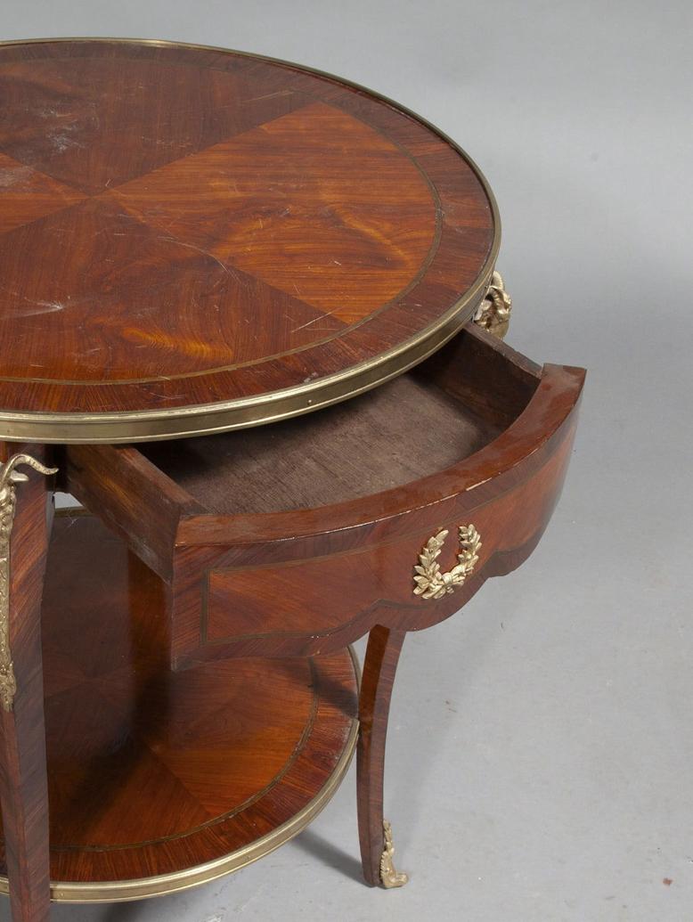Just in this French Louis XV-Louis XVI  transitional Style  Gueridon or side table with beautiful Marquetry throughout.
On the legs, the apron and the large round top, there are Bronze Mounts to the feet and Bronze ram heads to the top of each