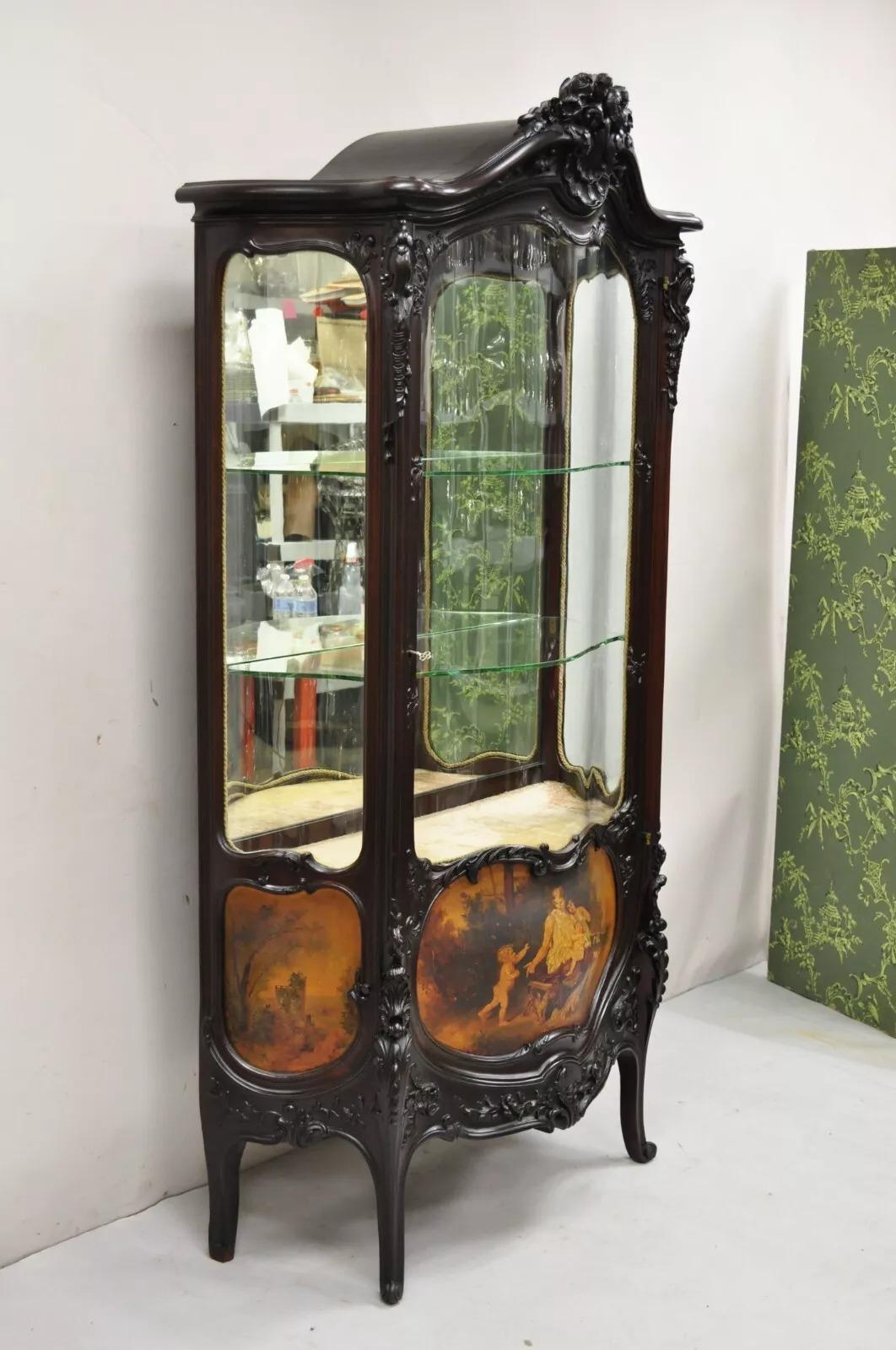 Antique French Louis XV Style Carved Mahogany Hand Painted Curved Glass Vernis Martin Curio Cabinet. Item features 3 serpentine curved glass panels, finely carved floral and acanthus scroll details, 3 hand painted scenes to lower, 2 curved glass