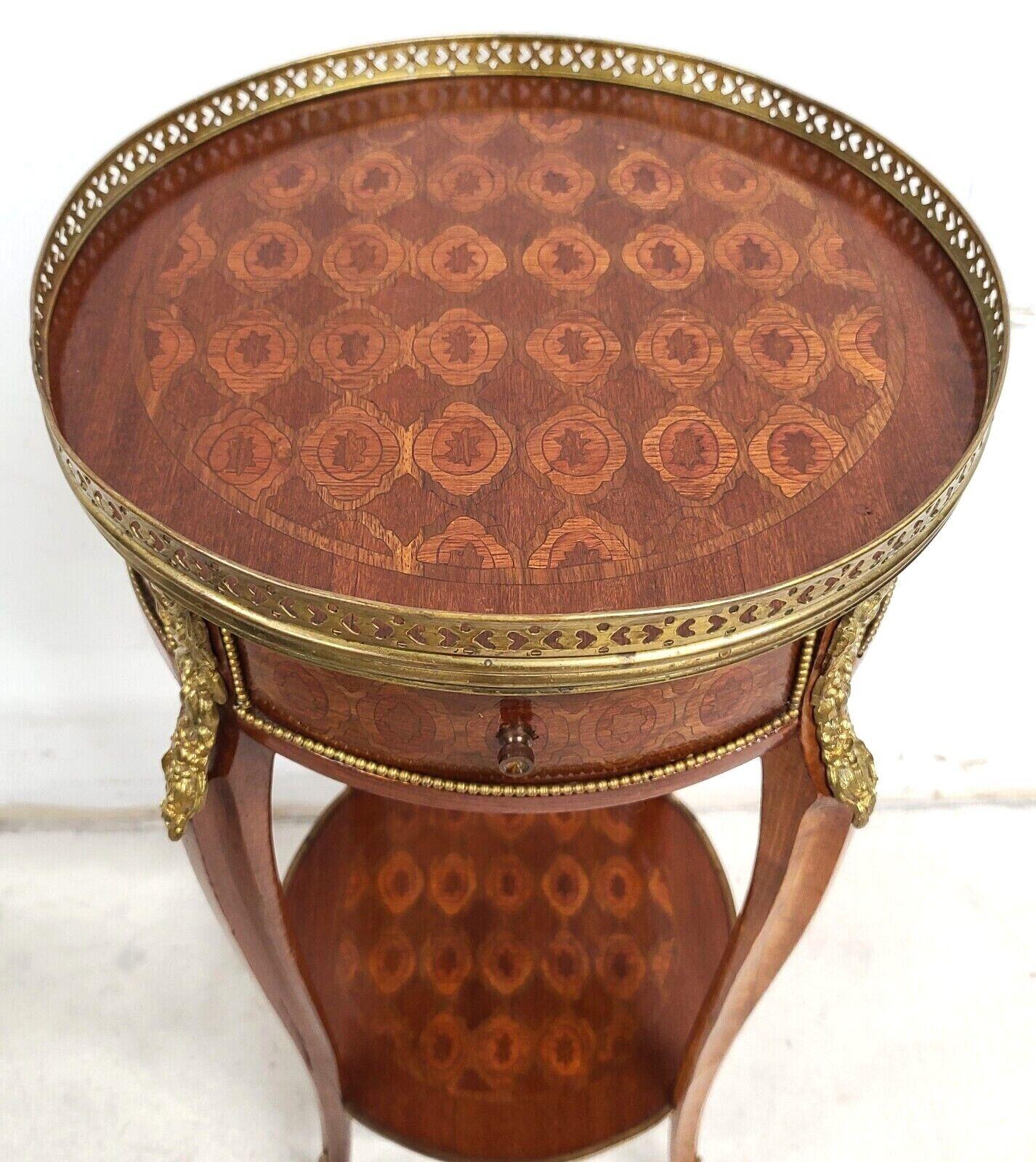Offering one of our recent palm beach estate fine furniture acquisitions of a French Louis XV Mahogany ormolu mounted petite lamp side table
With 1 drawer, brass reticulated gallery around top of table, inlaid top design, and bronze ormolu