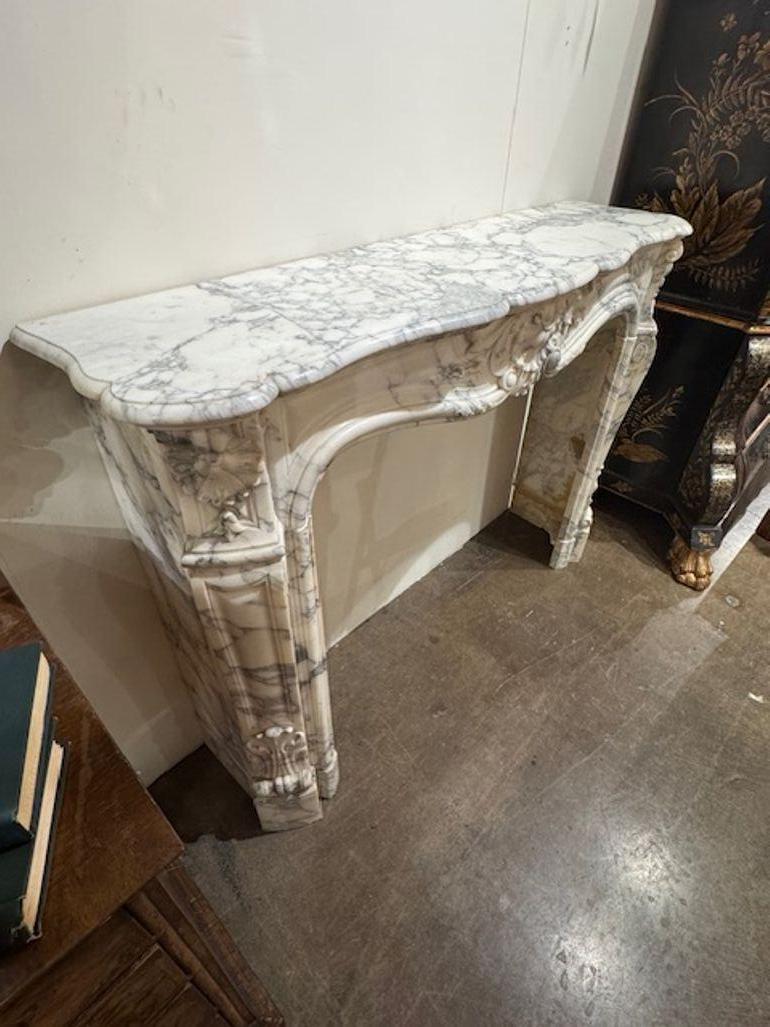 19th century French Louis XV style carved white breccia marble mantle. You're exploring a fireplace that blends Rococo elegance with sculptural drama—a French Louis XV–style carved white Breccia marble mantel is a showpiece of 18th- and 19th-century
