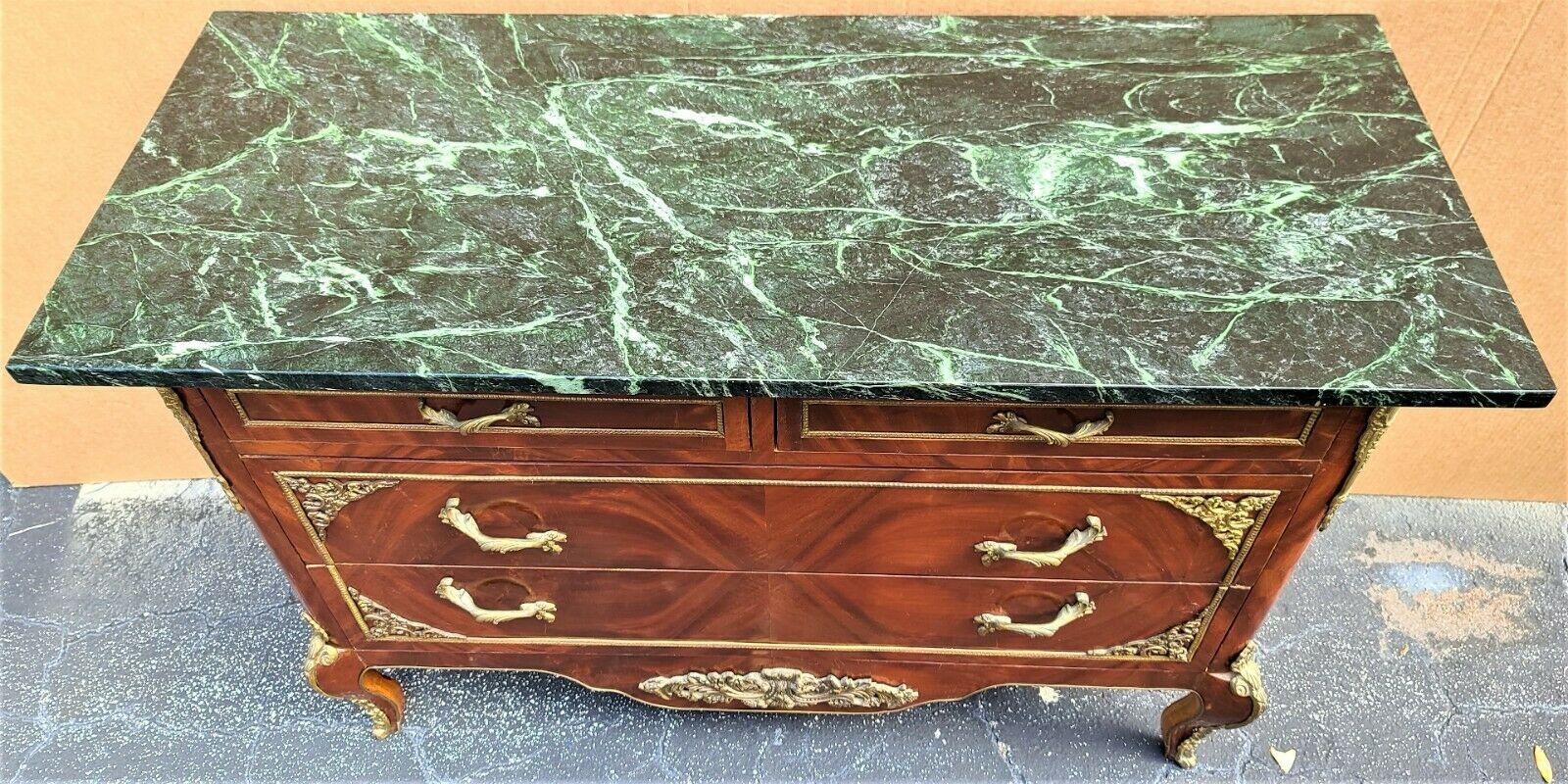 Offering one of our recent palm beach estate fine furniture acquisitions of a
French Louis XV marble top chest dresser tv stand with gilt ormolu mounts



Approximate measurements in Inches
33