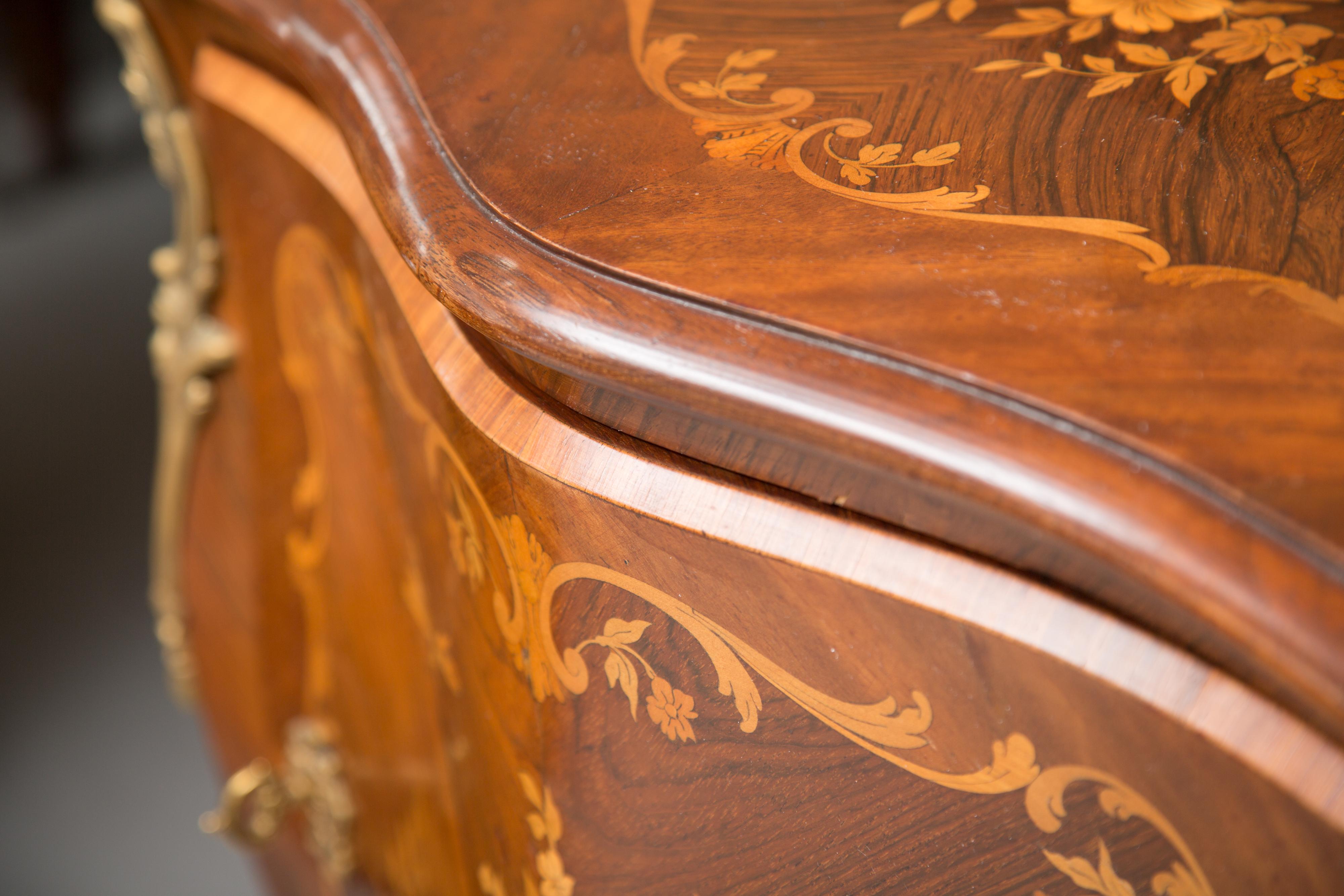 This is a delicate single-drawer cabinet shaped apron with marquetry top, door and sides. The case piece is supported by graceful splayed legs containing gilt metal sabots. Mid 20th century.