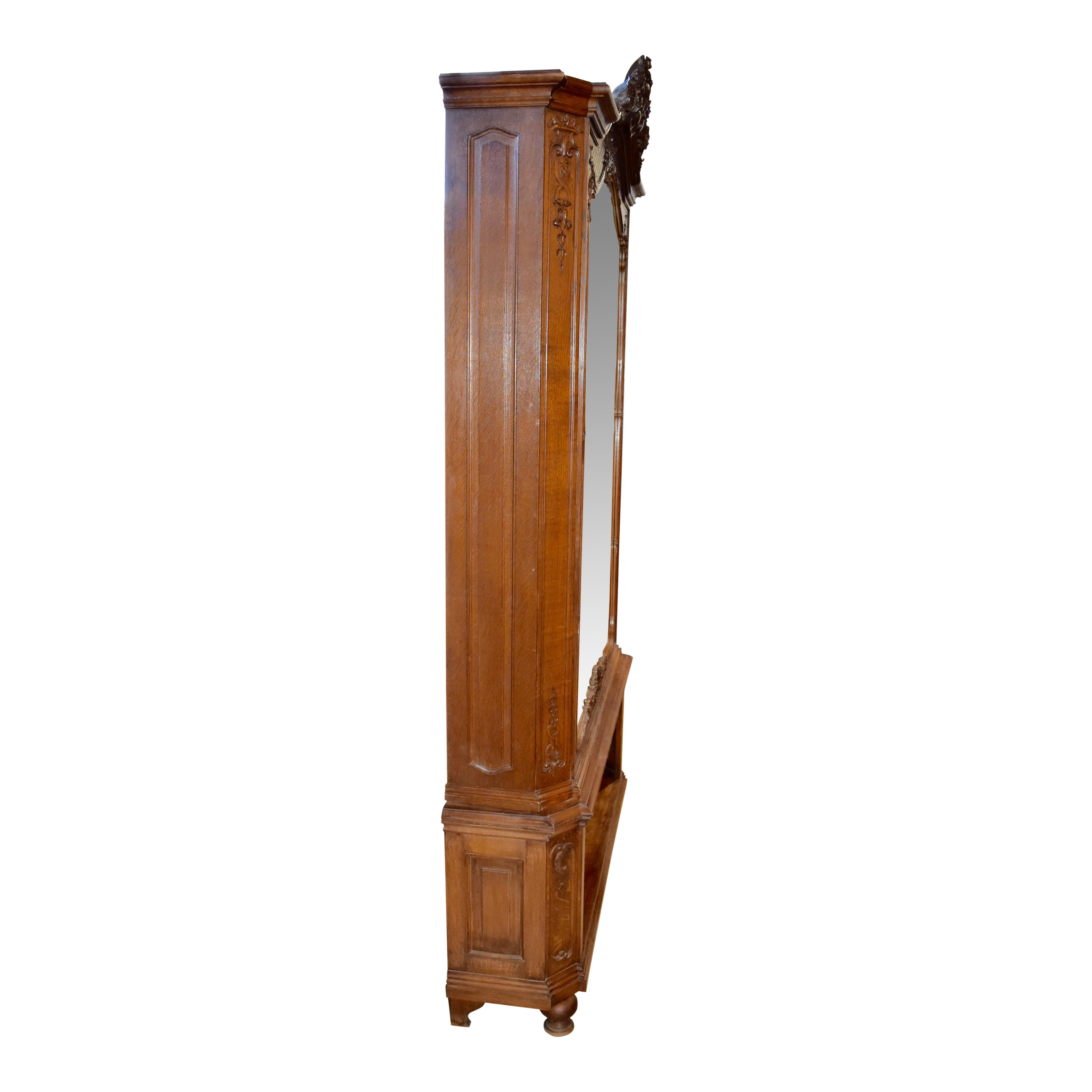 Add light and depth to any room with this substantial Louis XV dressing mirror. Its carved oak frame features an arched bonnet crowned with a bold display of fanned leaves flanked by small flowers nestled in scrolled leaves. Additional dainty