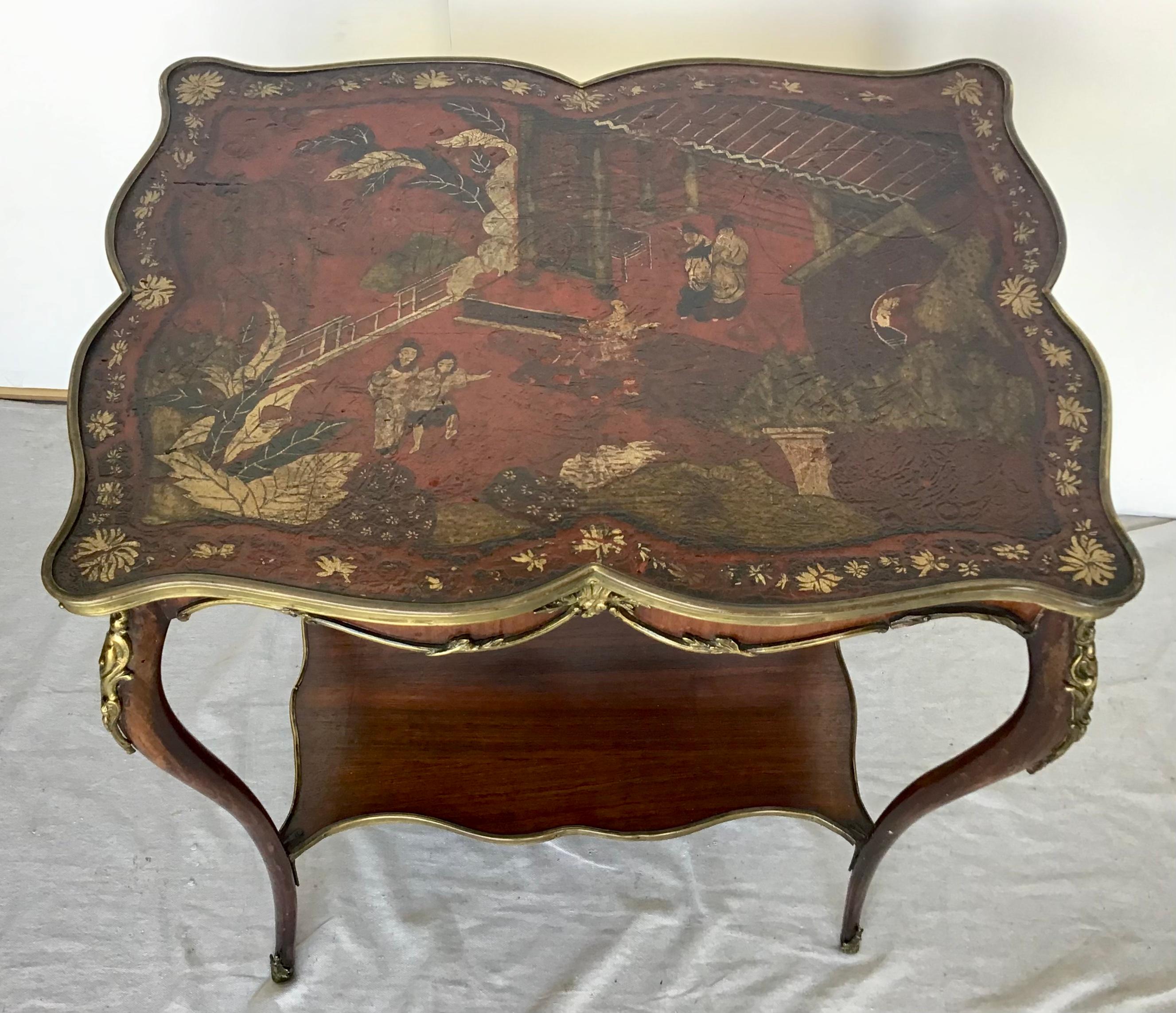 A very rare and unusual French Louis XV Chinoiserie lacquer, ormolu mounted side table, the lacquer leather top with bronze gallery, depicting a classical Chinese scene of a court scene and various figures walking down a path. Ormolu mounts all