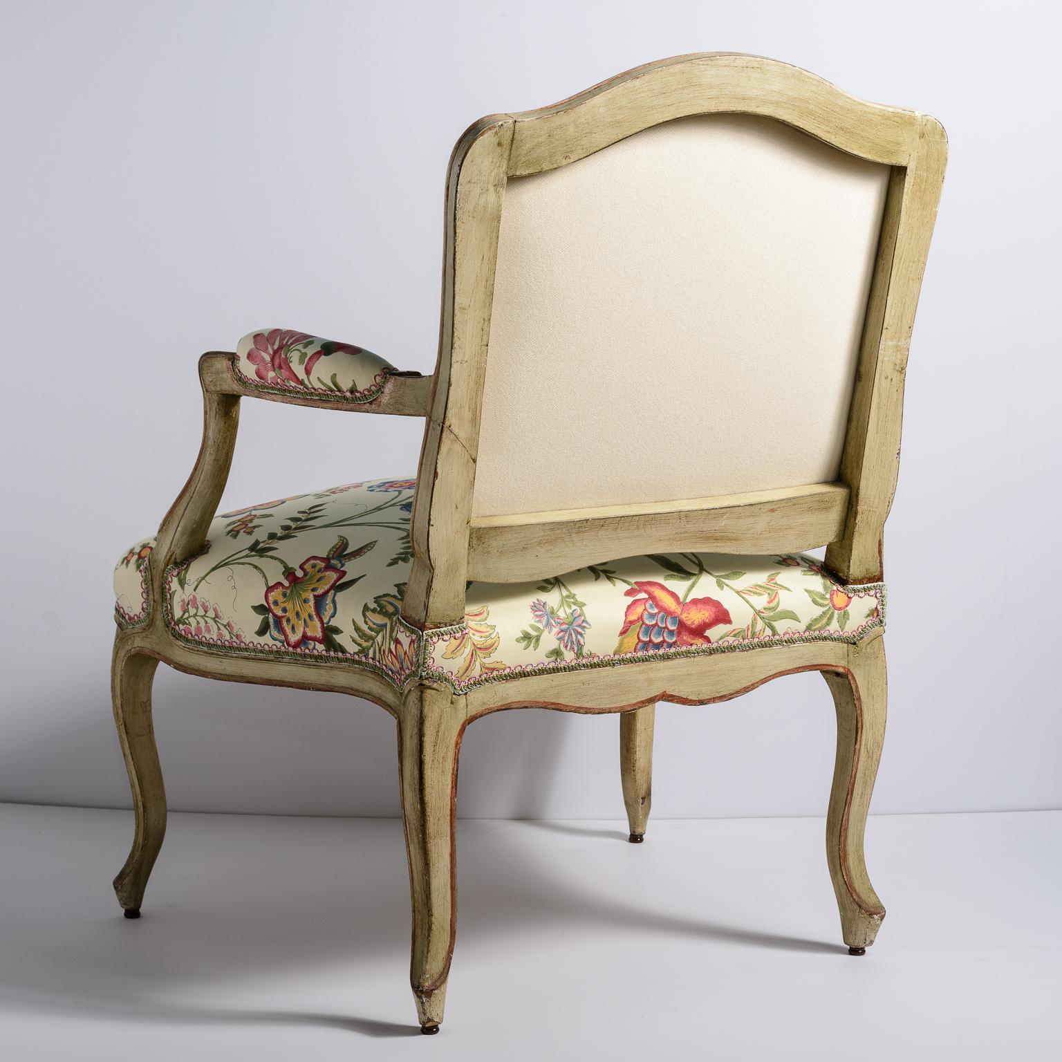 Pair of Period French Louis XV Painted Fauteuils,  18th C.
This pair has a cartouche-shaped padded back.
The arms are upholstered, the front and back have a  serpentine form and elegant cabriole legs.  These  type of chairs are characterized by its