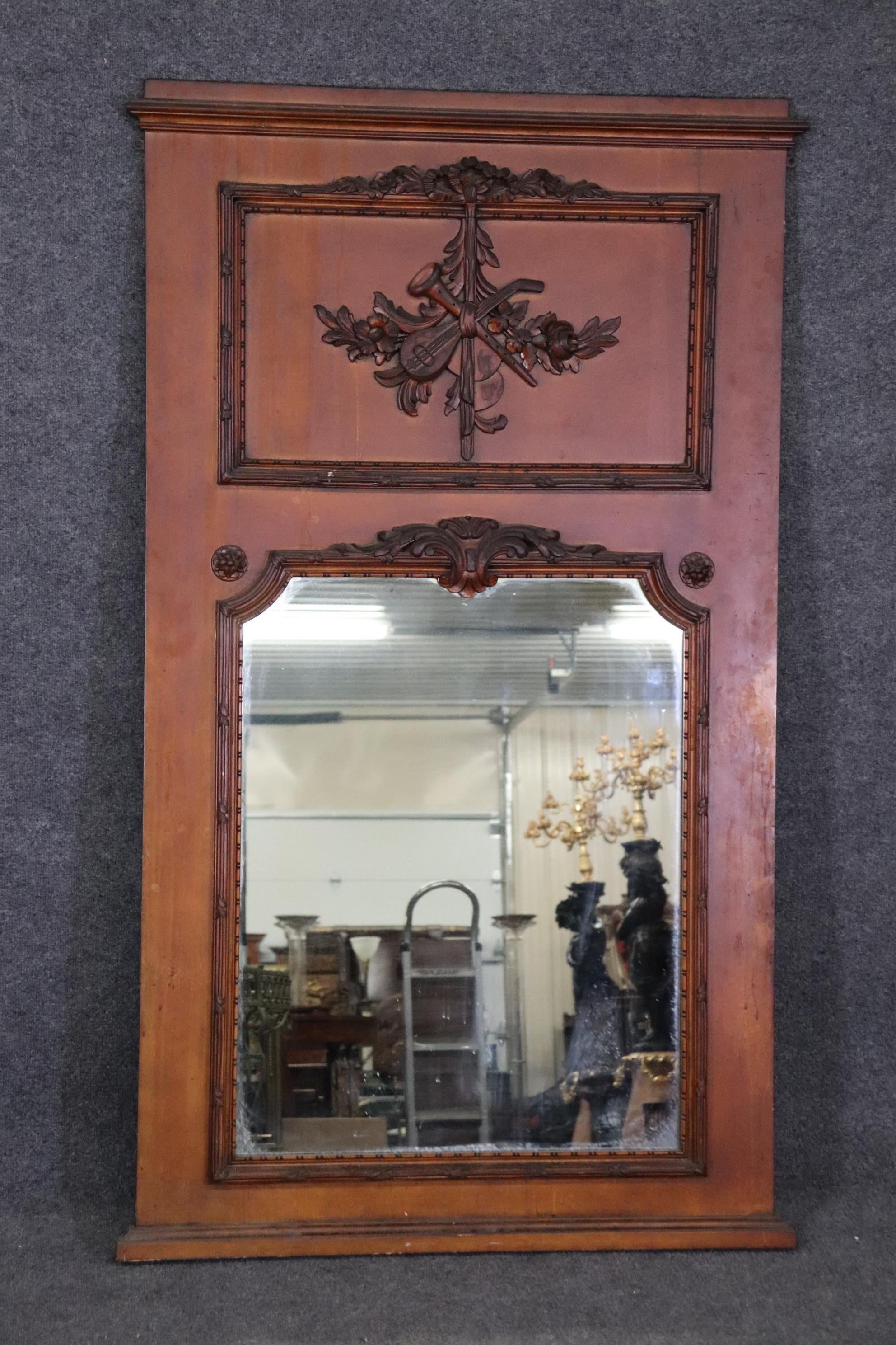 This is a brown paint decorated with carved details and measures 61 inches tall x 36 wide x 1.5 inches thick. The mirror is American made and will show minor signs of wear and use and seem to have some runs on the finish which can be painted over