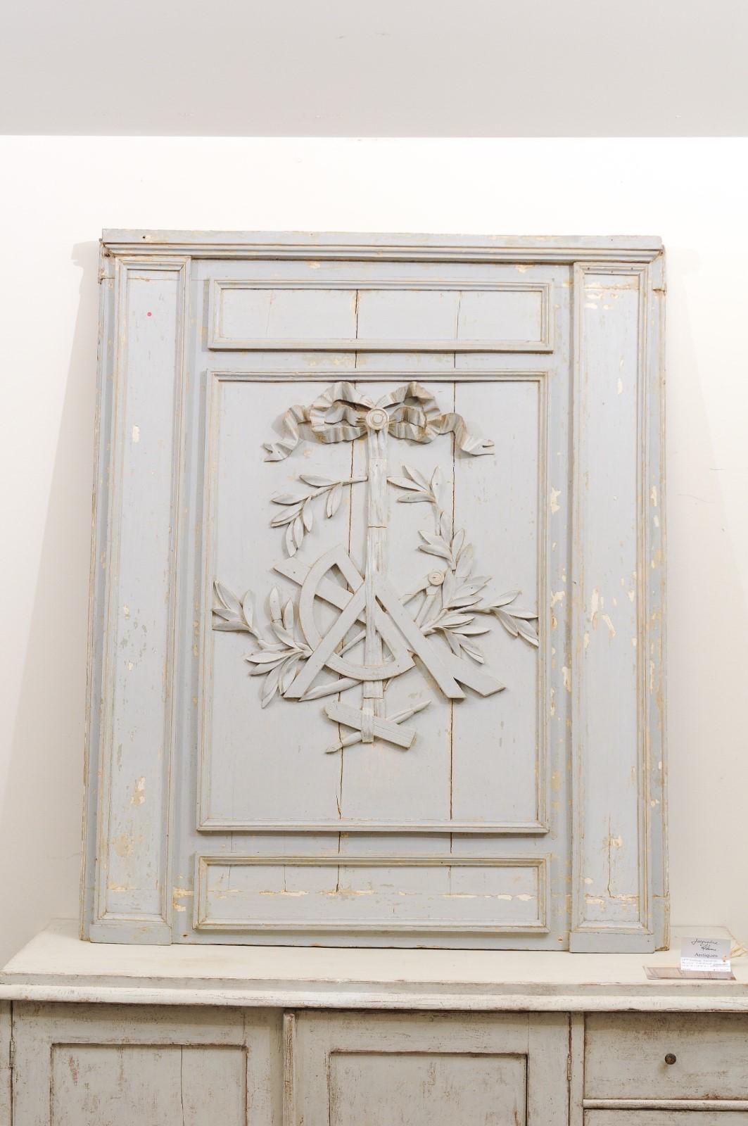 A French Louis XV period mid-18th century architectural panel from Burgundy scraped to its original paint, with ribbon-tied science trophy. Born in Burgundy during the later years of the reign of king Louis XV, this French architectural panel