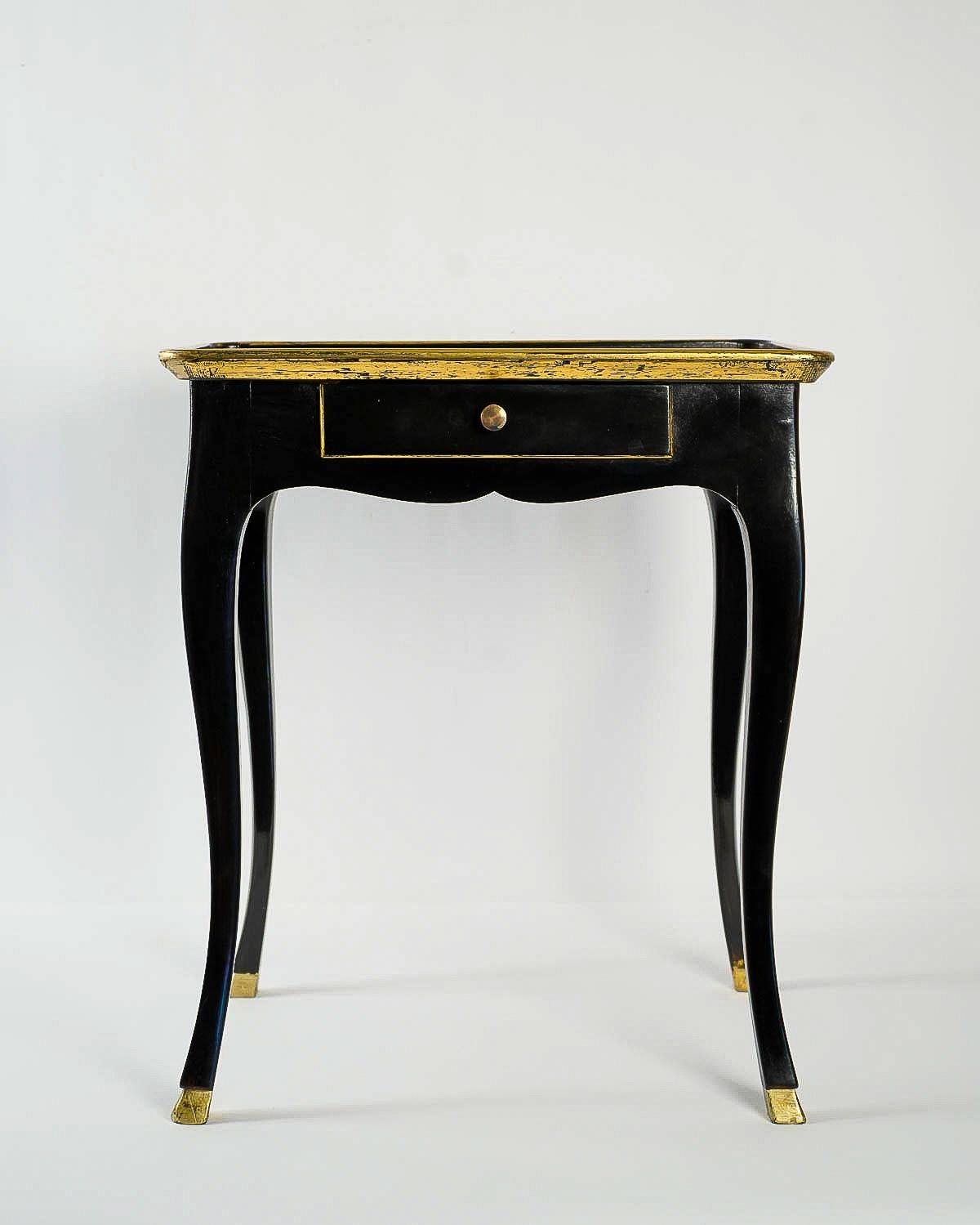 We are pleased to present you, an elegant and decorative black lacquered walnut and picked out gold Cabaret table. Our cabaret table raised on serpentine legs. One drawer. On the top a lovely red leather.

Beautiful French Louis XV period Cabaret