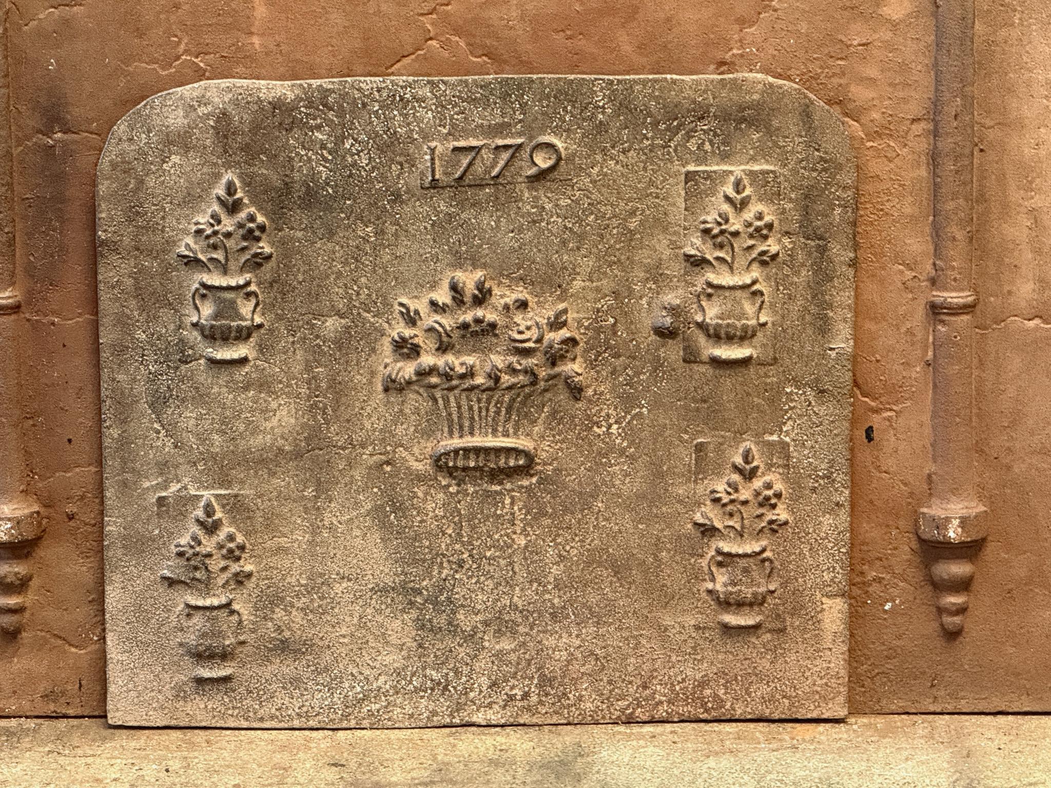 18th Century French Louis XV Period fireback with flower baskets. The date of production, 1779, is also cast in the fireback

The fireback is made of cast iron and has a brown patina. Upon request it can be made black / pewter at no extra costs. The