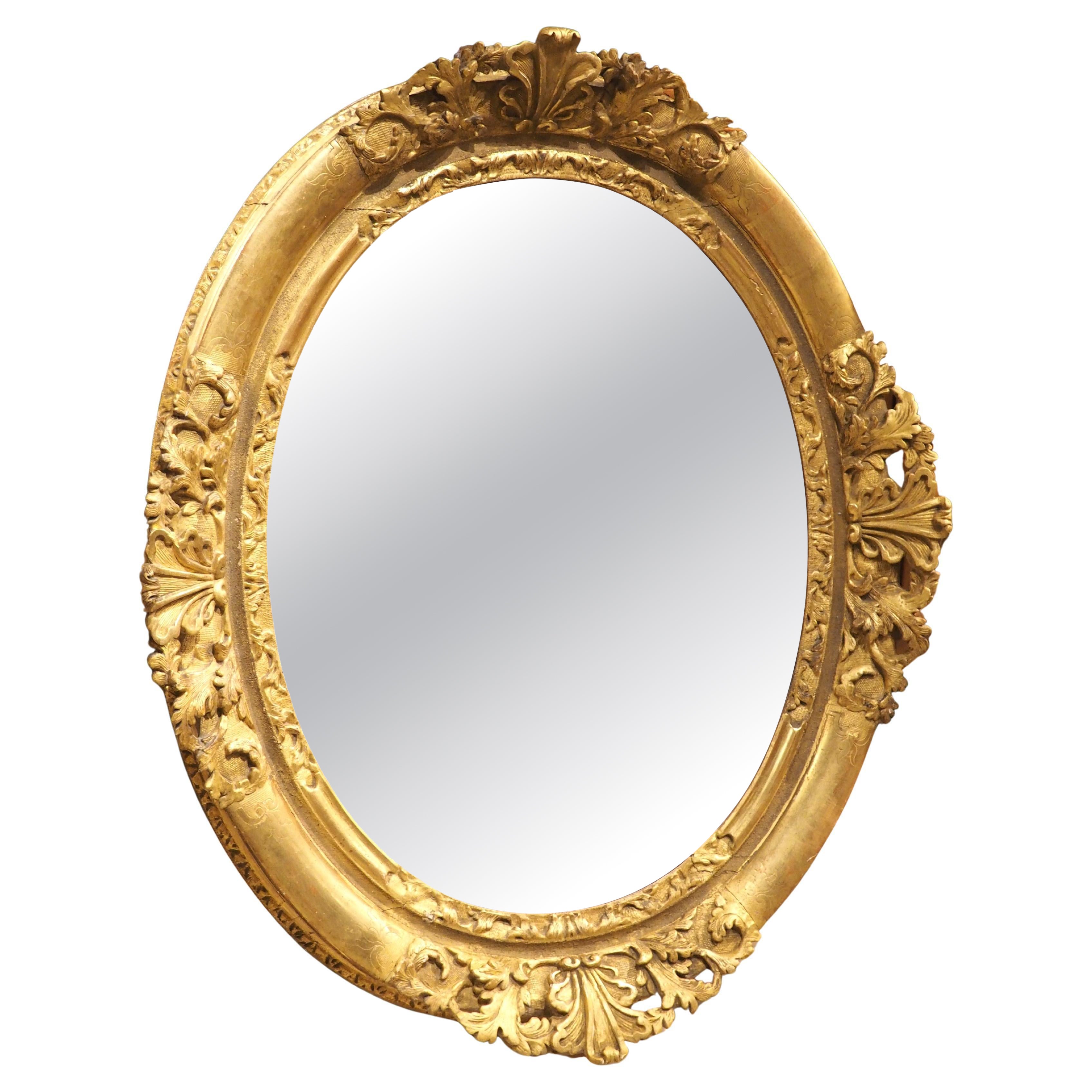French Louis XV Period Oval Mirror in Carved and Gilded Wood, Circa 1750