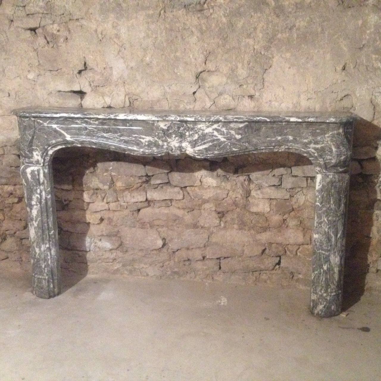 A French original Louis XV period fireplace in 
