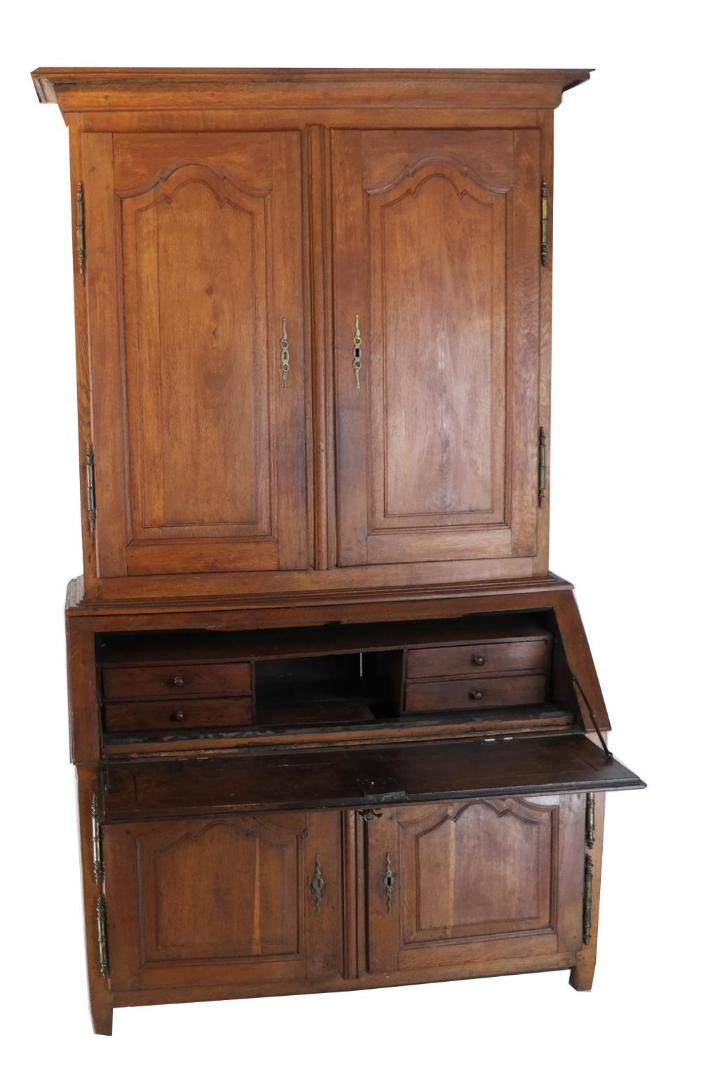 A French 2-part secretaire desk with upper bookcase, circa 1770 in oak, with nicely paneled doors and a fitted interior desk compartment.
