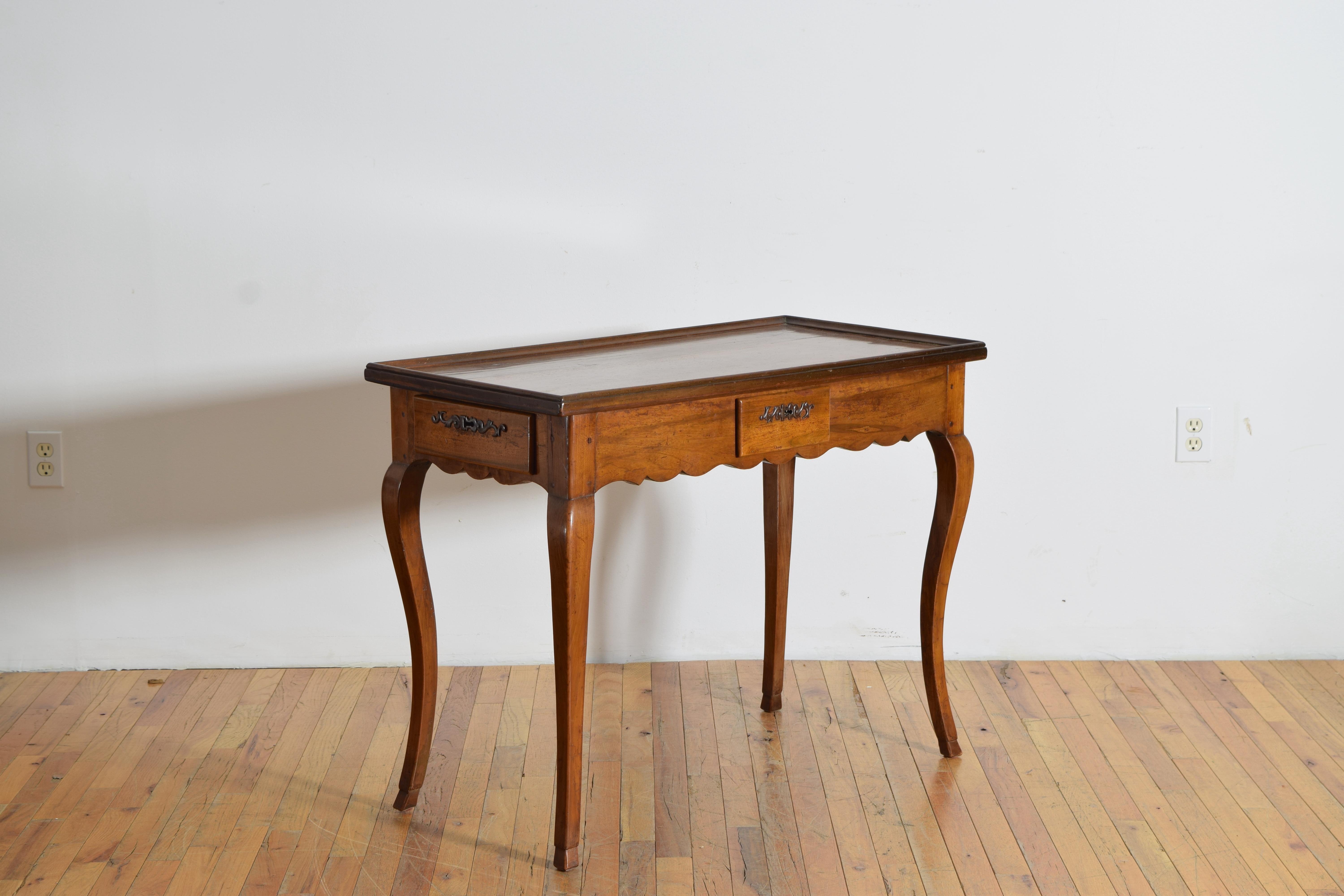 in pristine original condition and having a rectangular top with raised gallery edge atop a conforming case with a uniquely shaped apron and three uniquely positioned drawers, the case raised on tapering cabriole legs