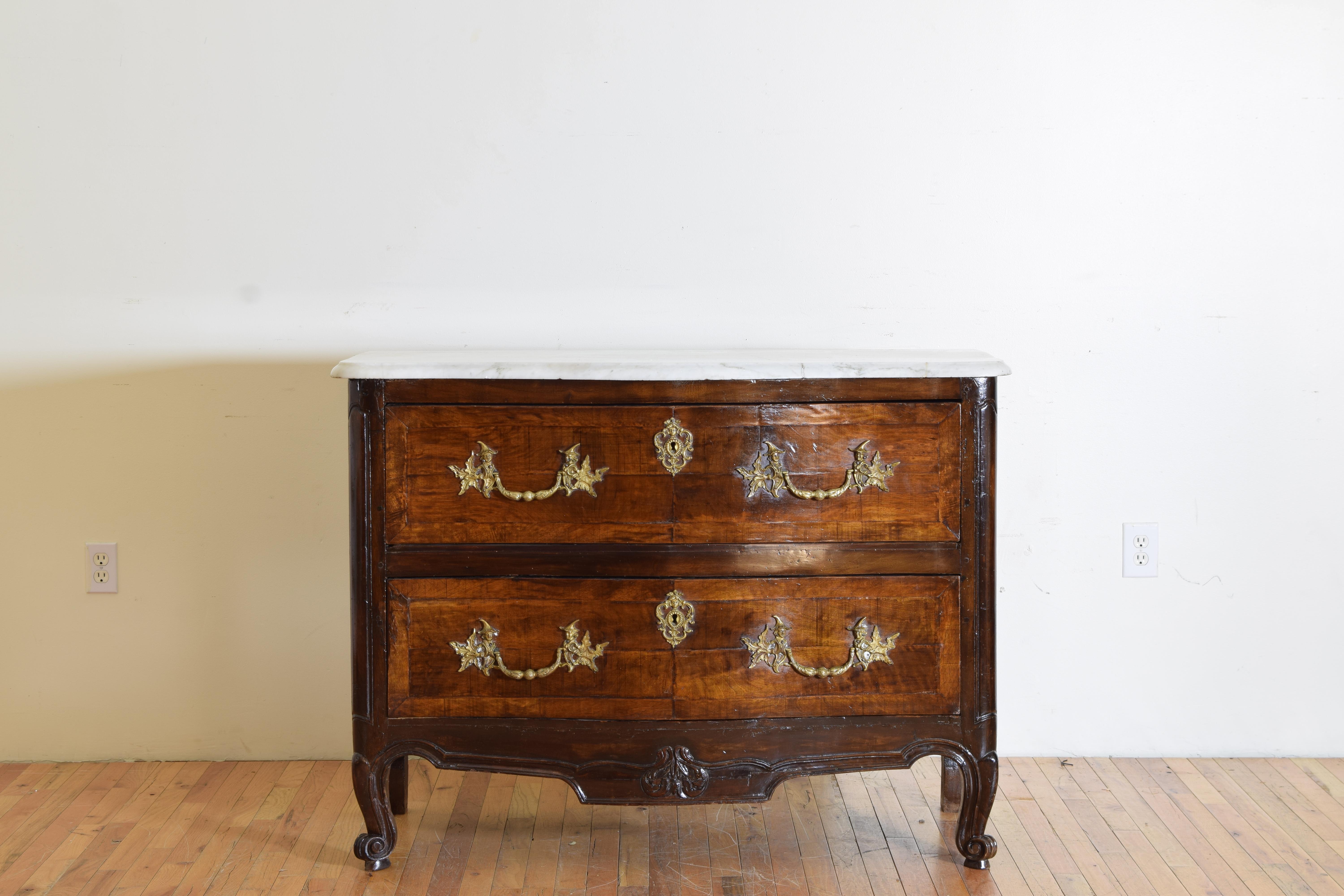 this highly stylized two drawer commode is a fine example of the influence of the Chinoiserie style sweeping Europe in the 18th century.  of serpentine shape and retaining its original marble top this commode is constructed of walnut with the