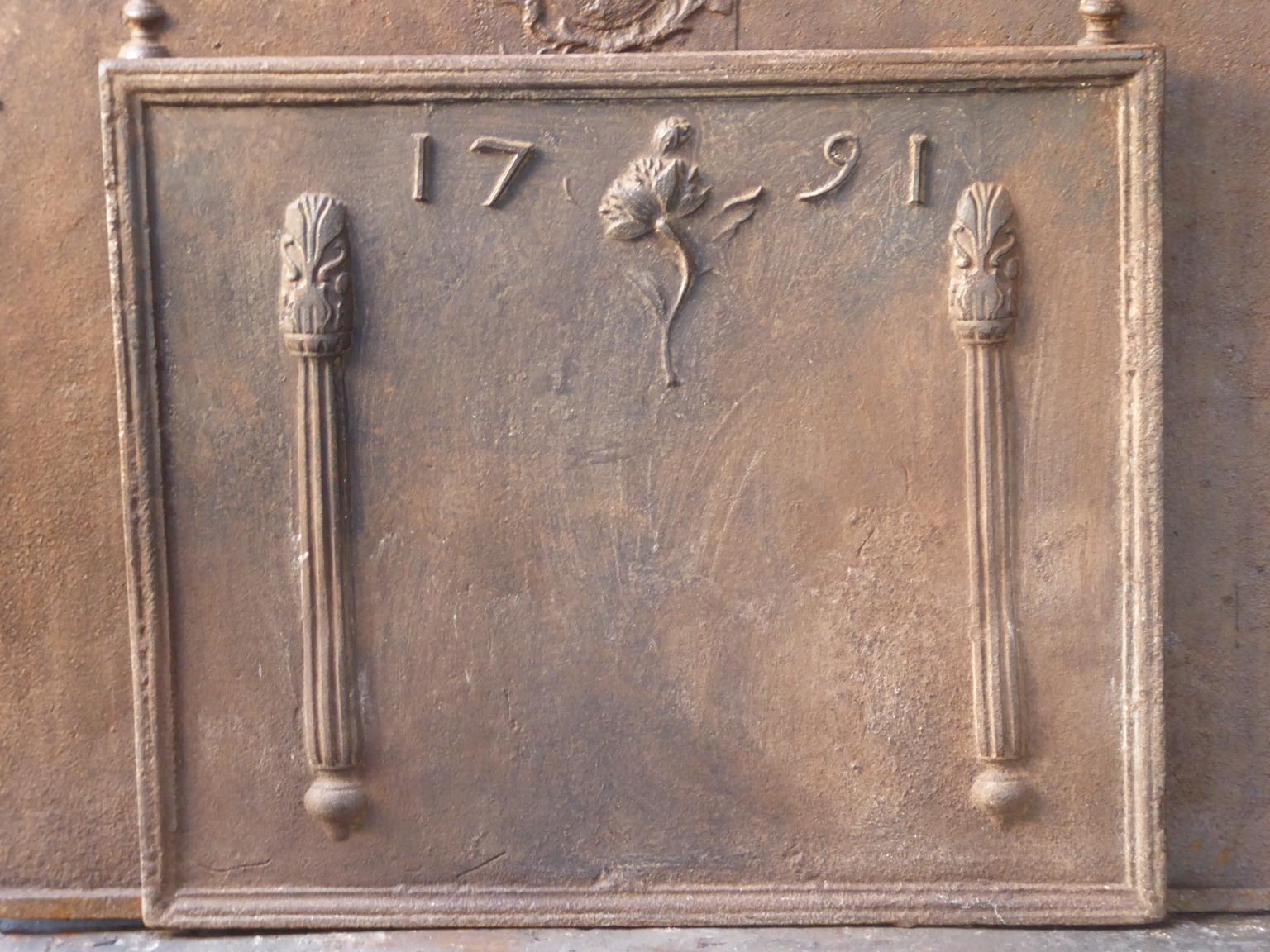 18th century French Louis XV fireback with two Pillars of Hercules. The pillar refers to the club of Hercules and symbolizes strength and the unknown. The date of production, 1791, is also cast in the fireback.

The fireback has a natural brown