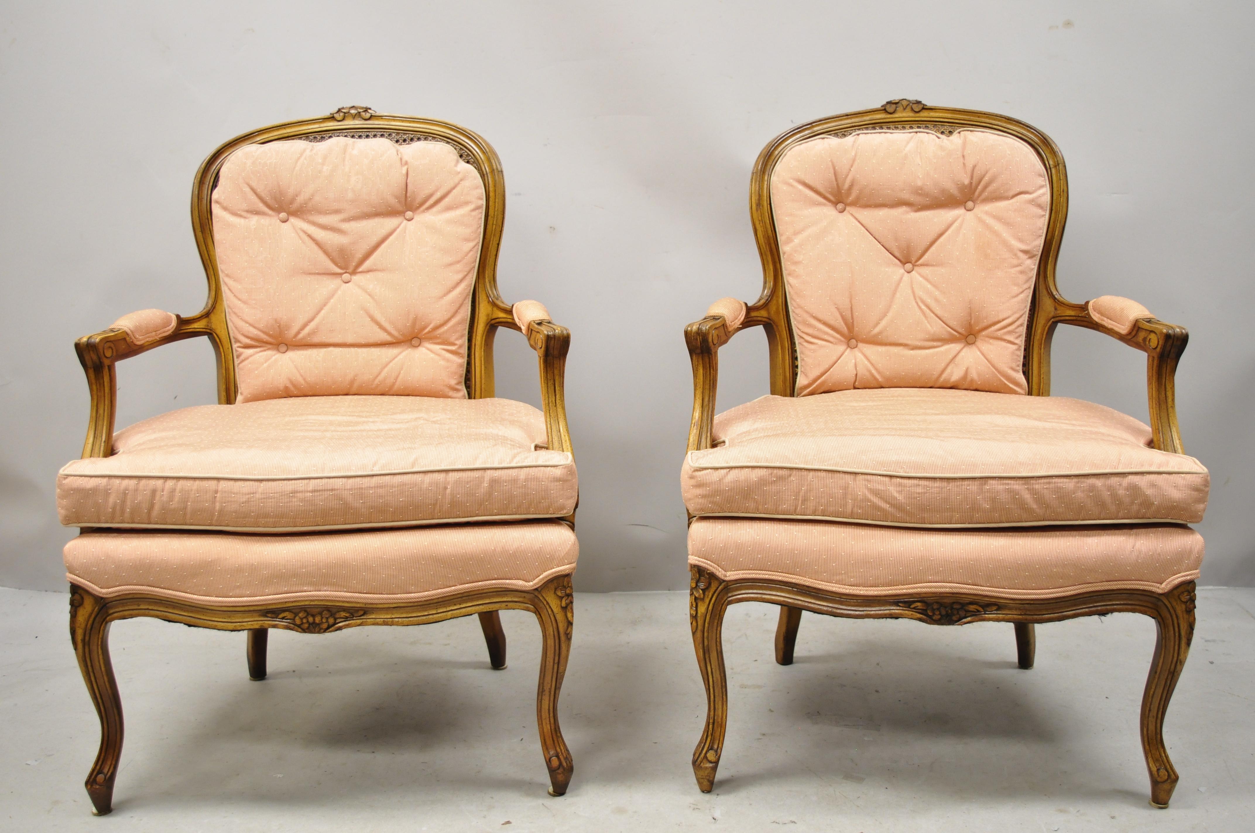 French Louis XV Provincial style carved walnut cane back armchairs - a pair. Item features cane backs, solid wood frame, upholstered armrests, nicely carved details, cabriole legs, very nice vintage item, great style and form, circa early to