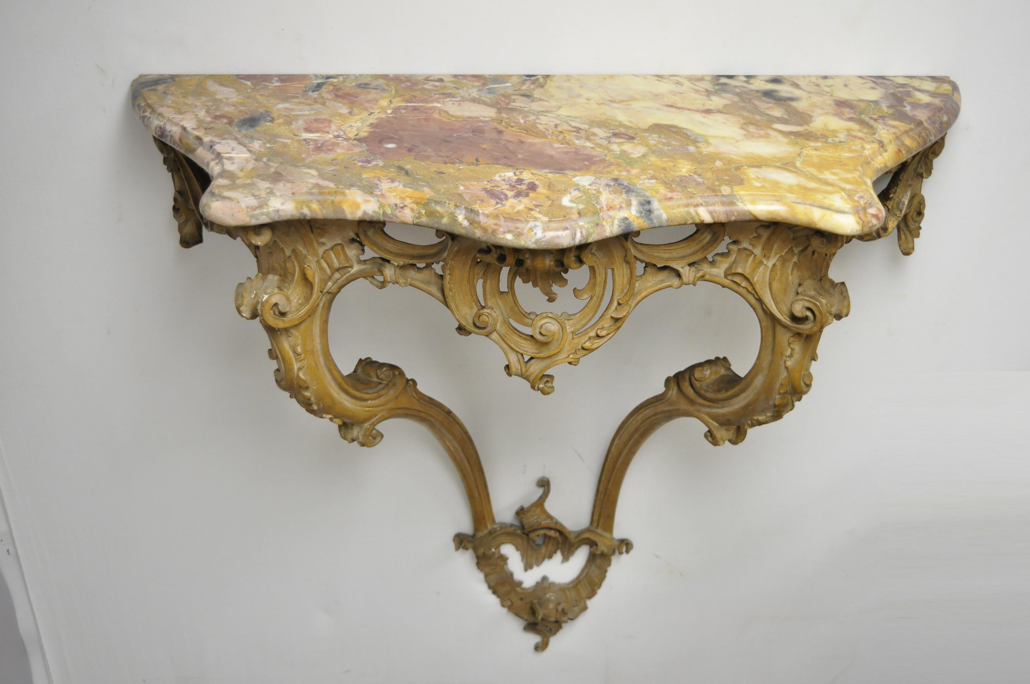 Antique French Louis XV Rococo Italian wall-mounted carved wood and marble-top console table. Item features hand carved acanthus scrollwork wooden base, shaped marble top, very nice antique item, table to be mounted to wall (mounting hardware not