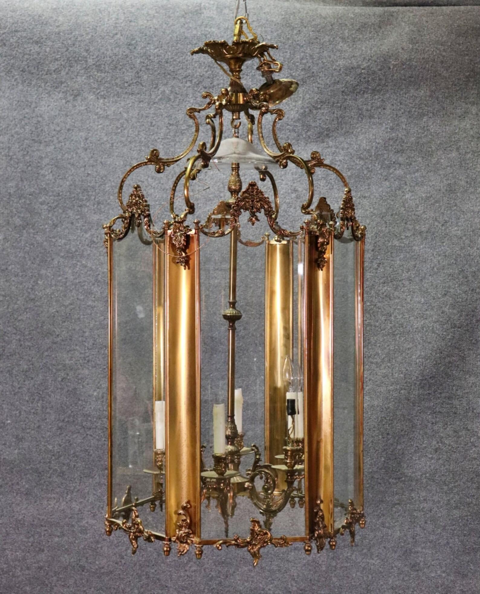 Dimensions- H: 42in W: 22 1/2in D: 21in

This vintage French Rococo style brass lantern chandelier is perfect for you and your home! This would be a wonderful addition to your entryway, kitchen, office or place of your choosing and is bound to bring