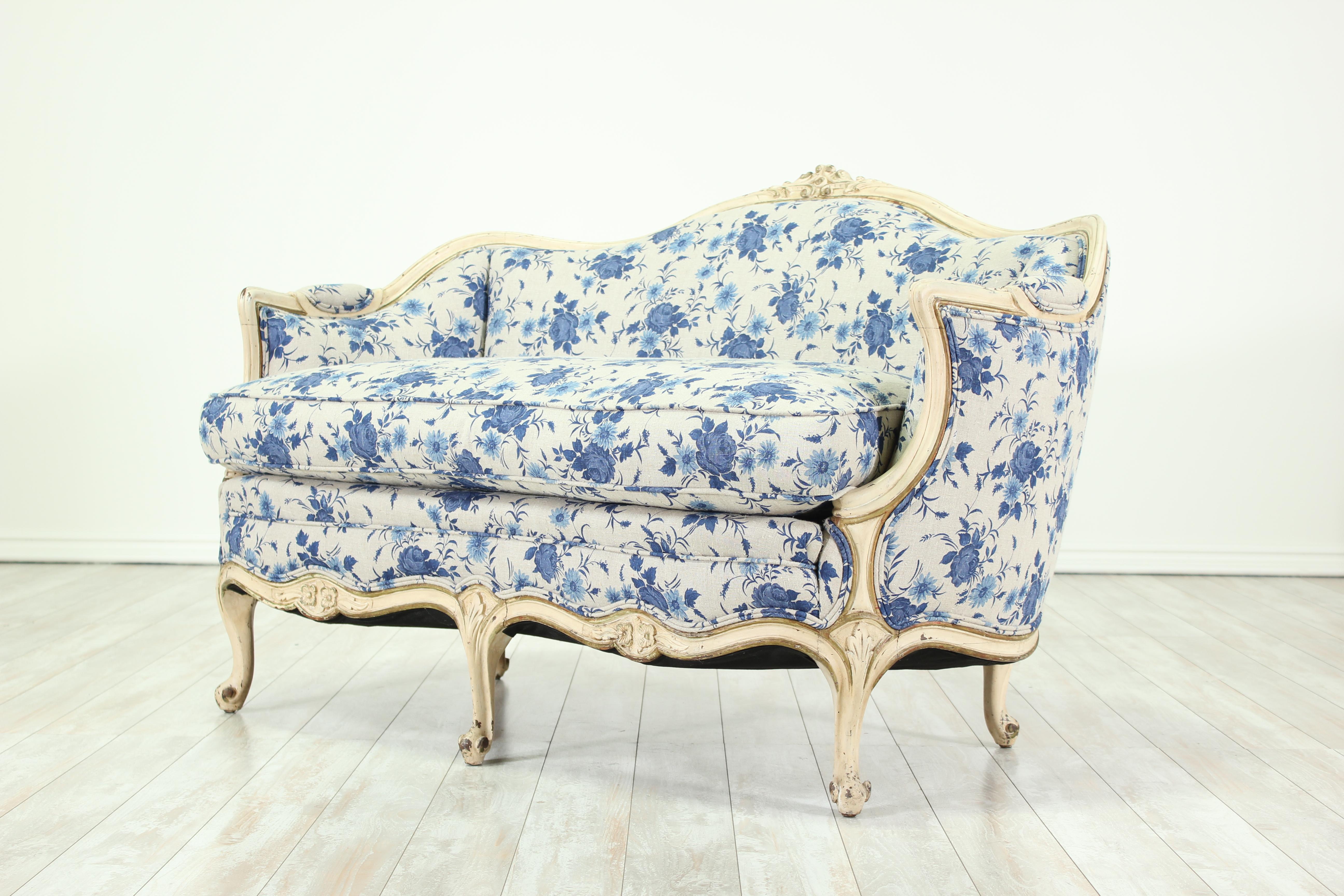 Pretty, 1940s Louis XV-style painted and carved settee with a new blue and white floral-printed linen upholstery. Loose seat cushion.
