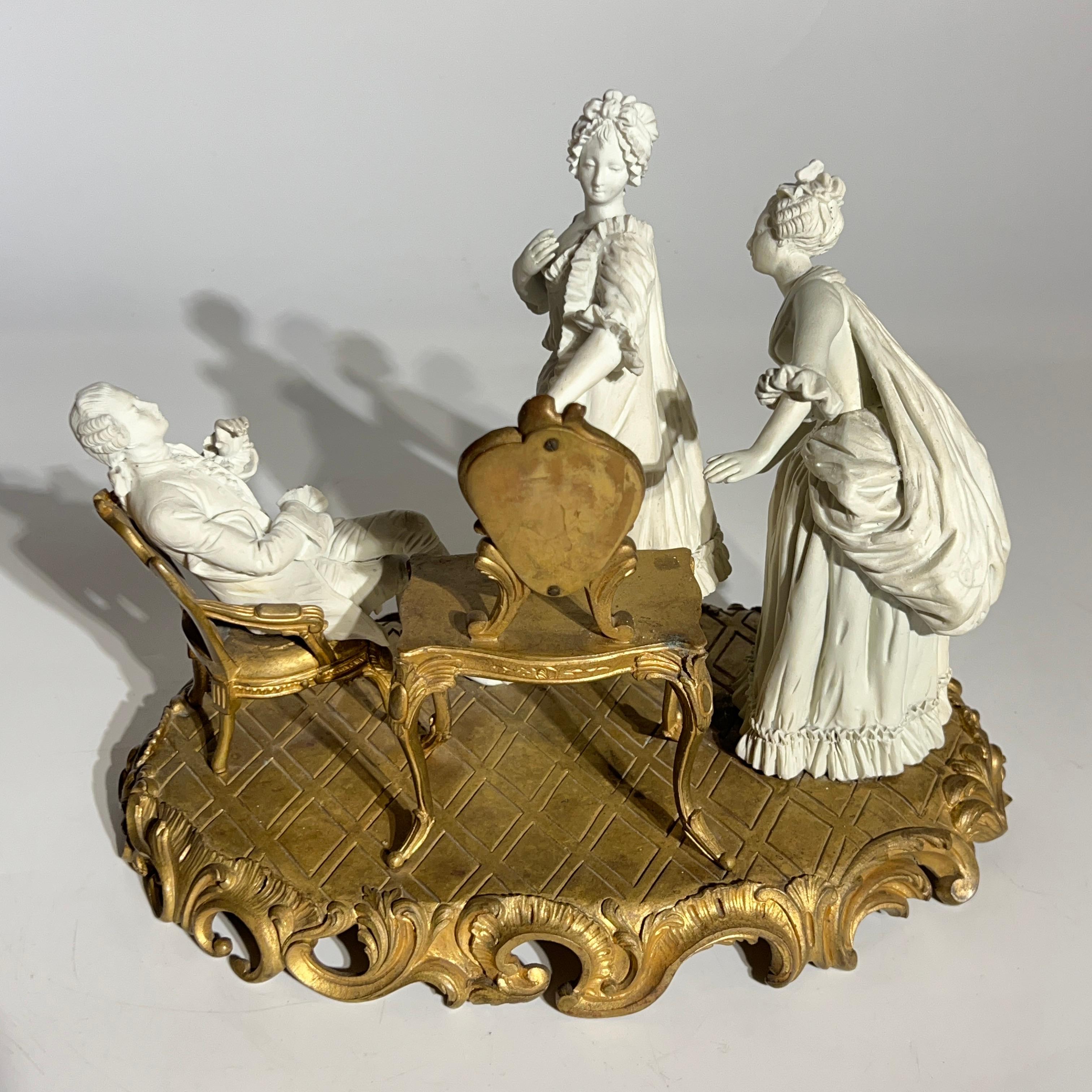 Antique (19th century) bisque porcelain group depicting an 18th century scene of a woman standing before her dressing table mirror with her attendant to her left, and her admiring gentleman seated to her right.  With Sevres hallmark.