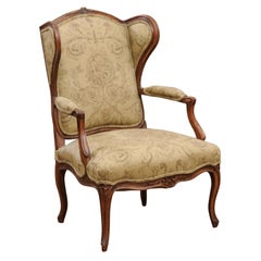 French Louis XV Style 1890s Wingback Chair with Upholstery and Carved Motifs