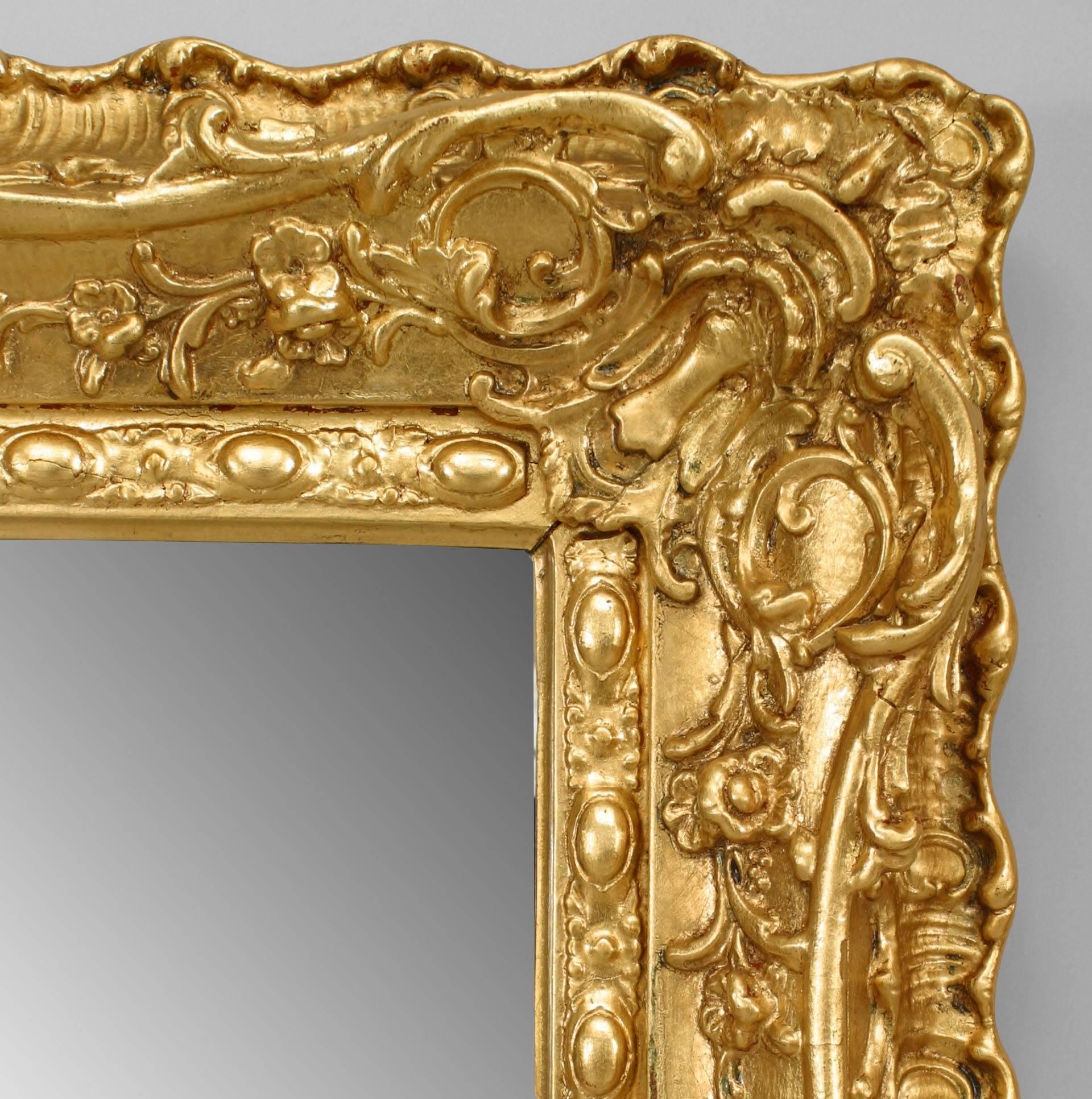 French Louis XV-style (19/20th Century) carved giltwood wall mirror with bevelled glass.
