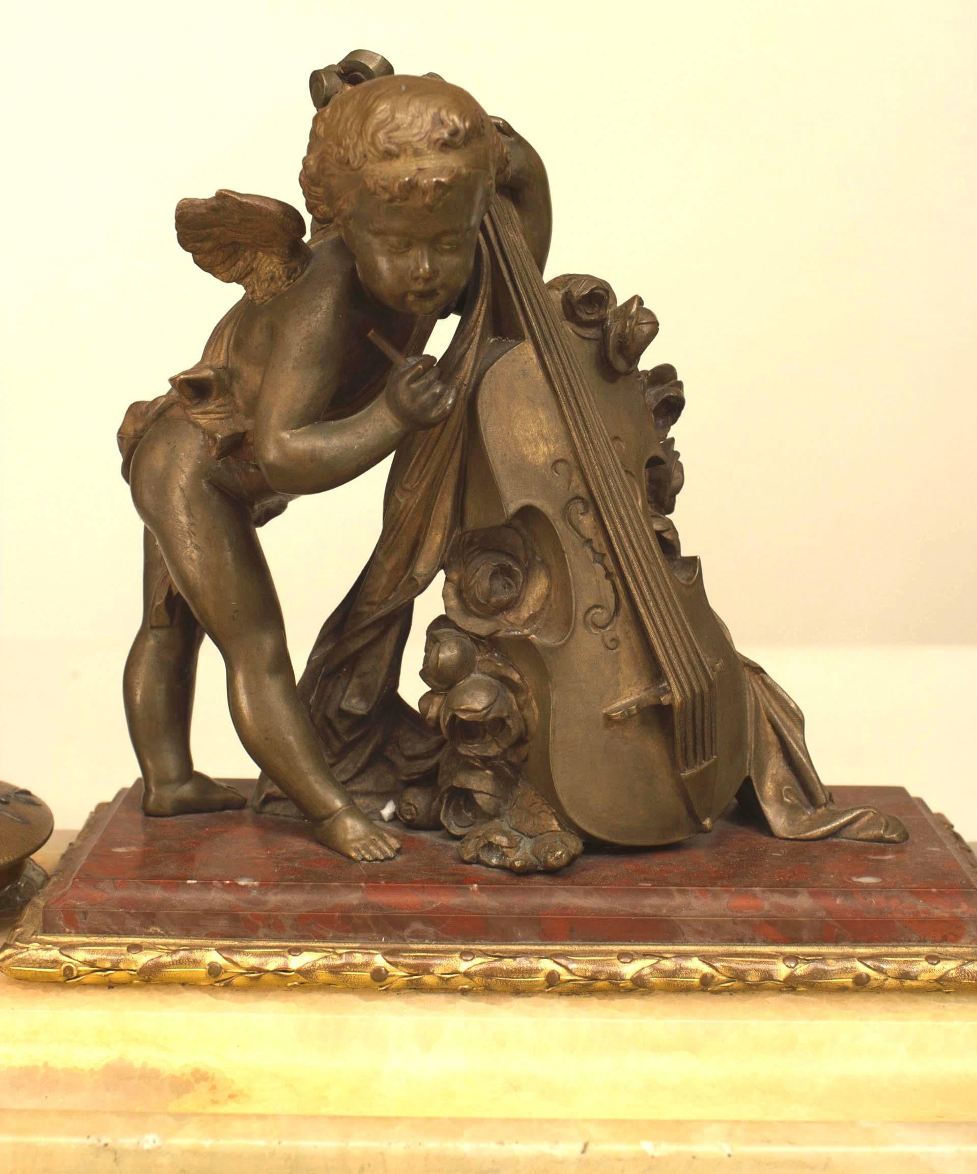 French Louis XV-style (19th Century) bronze double inkwell with trophy caps and cupid playing the cello on a white onyx base.
