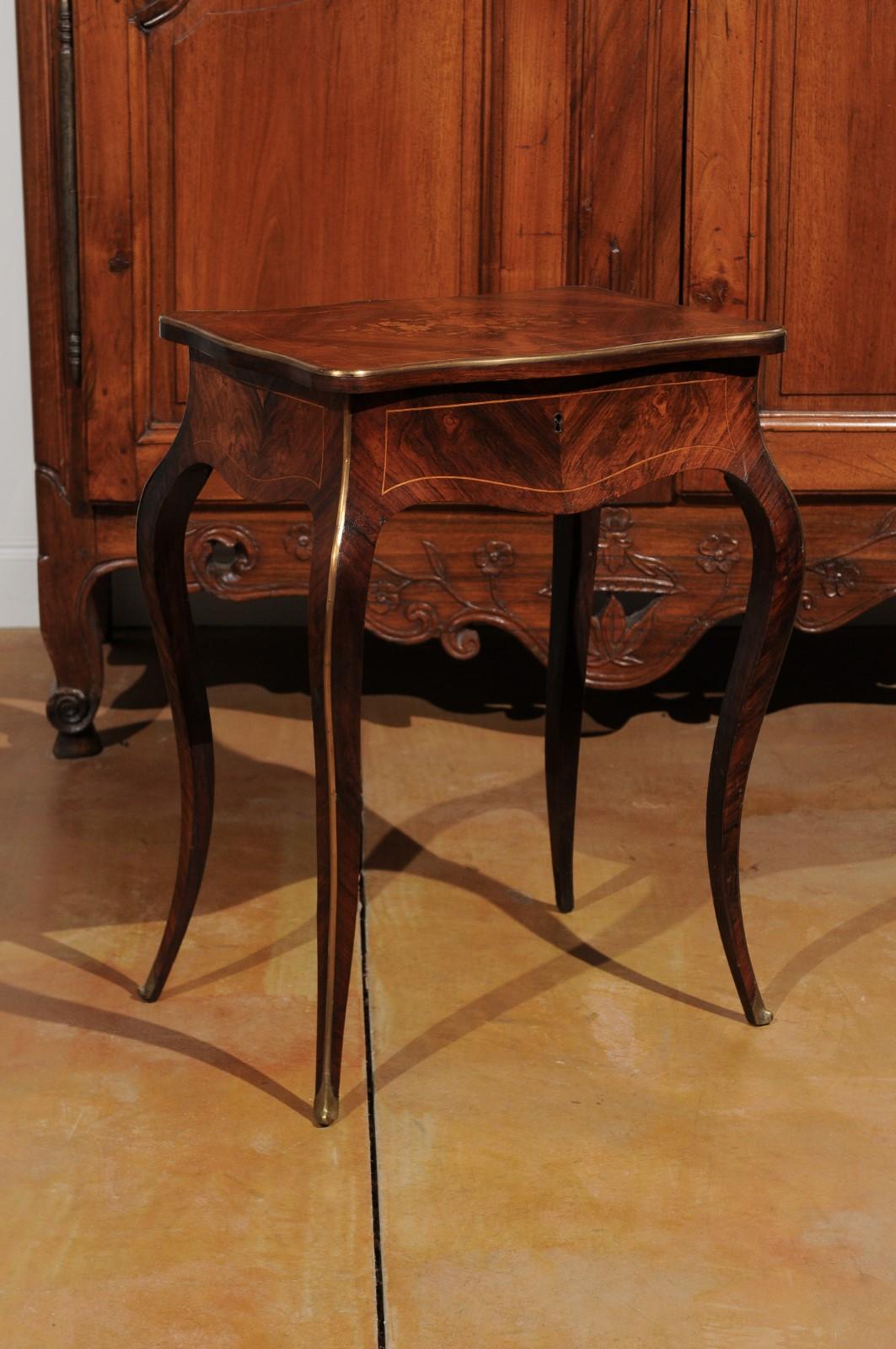 A French Louis XV style marquetry dressing table from the 19th century, with floral motifs and cabriole legs. Born in France during the 19th century, this exquisite marquetry table features the characteristics of the Louis XV era. The lovely top,