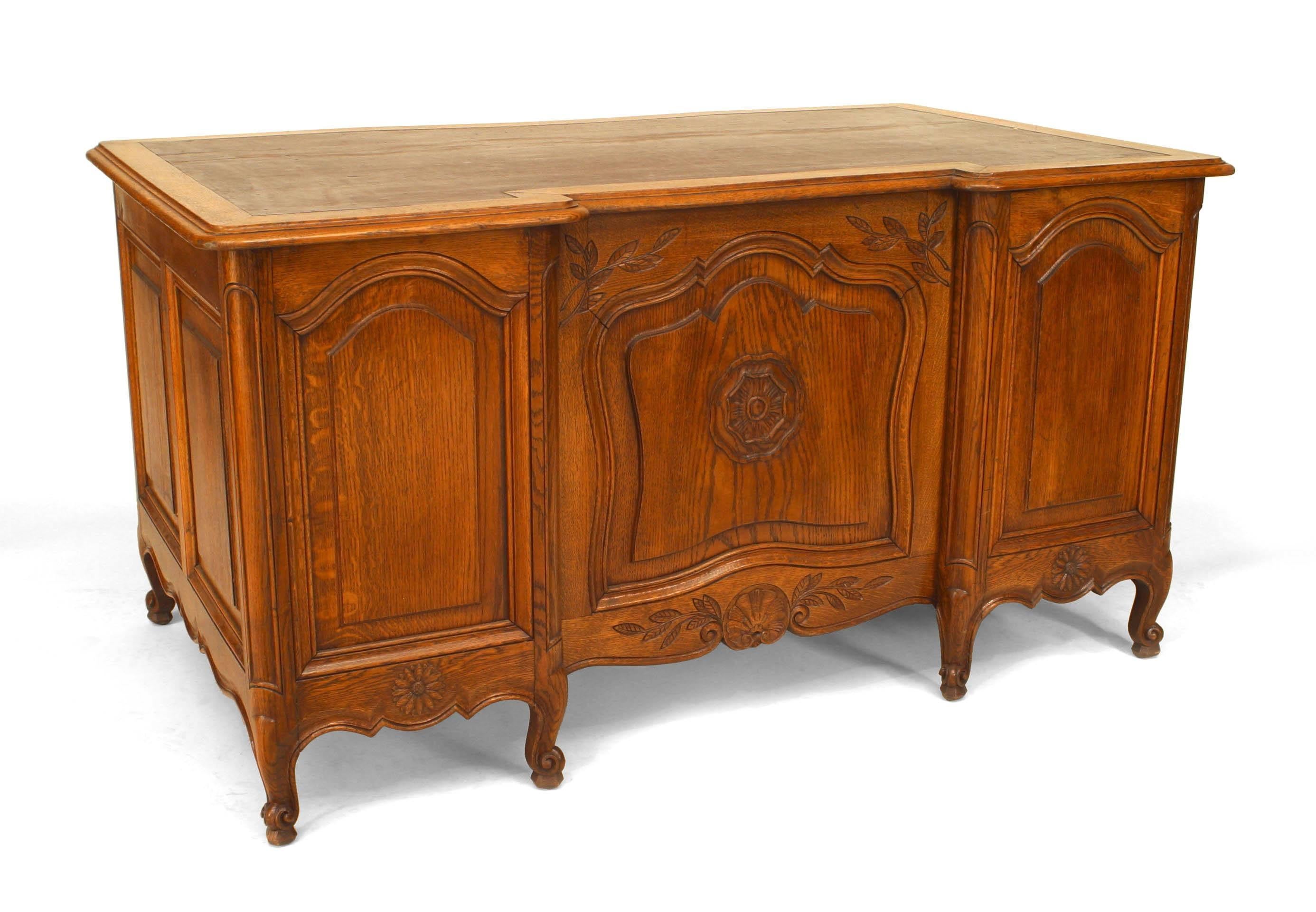 French Louis XV style (19th Century) provincial oak kneehole desk with brown leather top.
