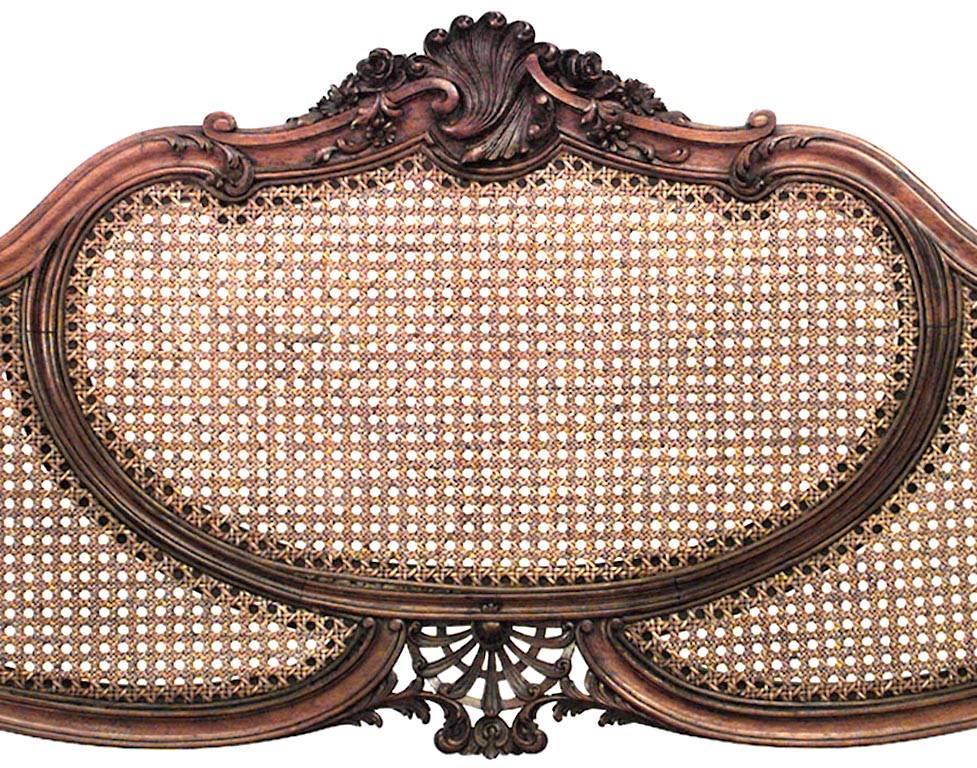 French Louis XV style (19th century) walnut loveseat with three paneled cane back.
 