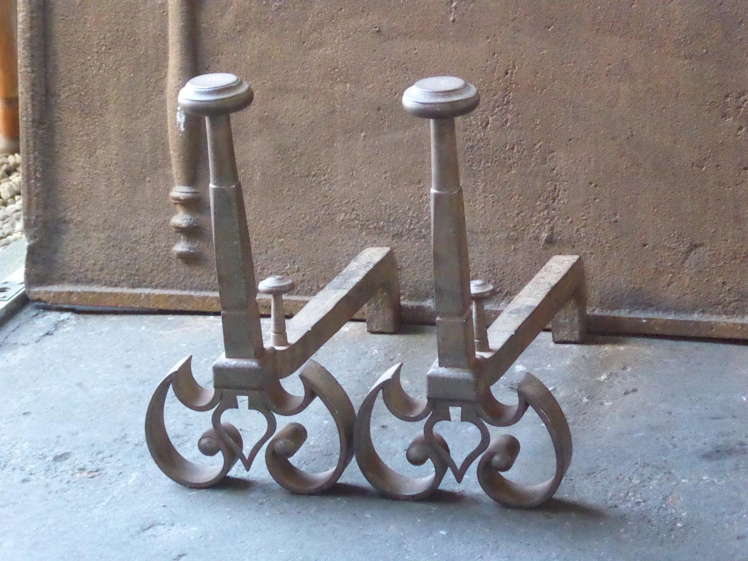 20th century French andirons made of wrought iron. The style of the andirons is Louis XV. They are in a good condition.