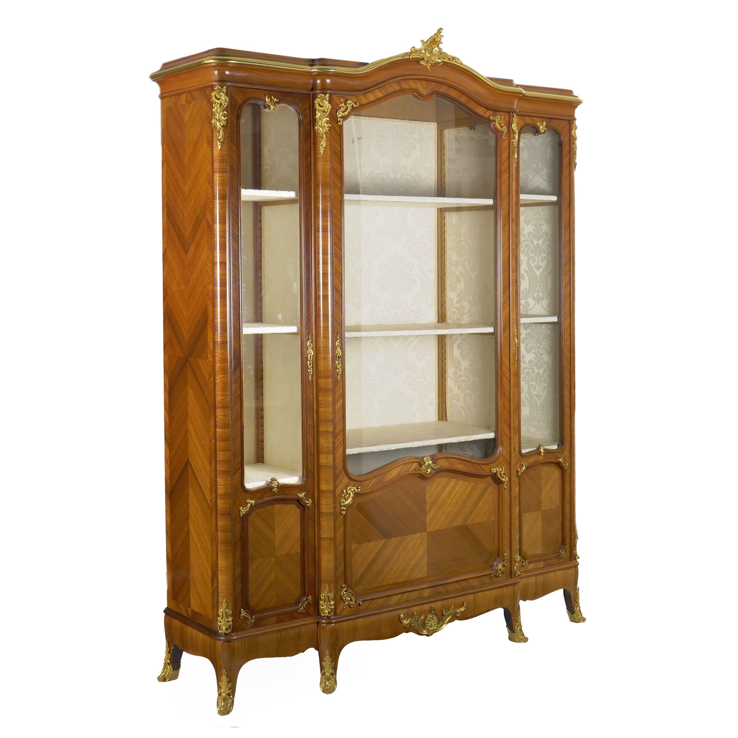 An exceedingly fine work of art, this bookcase cabinet is of the highest quality, designed with a careful eye to form, function and longevity. Designed with an eye to the Louis XV period, it is a product of the turn of the century, crafted between