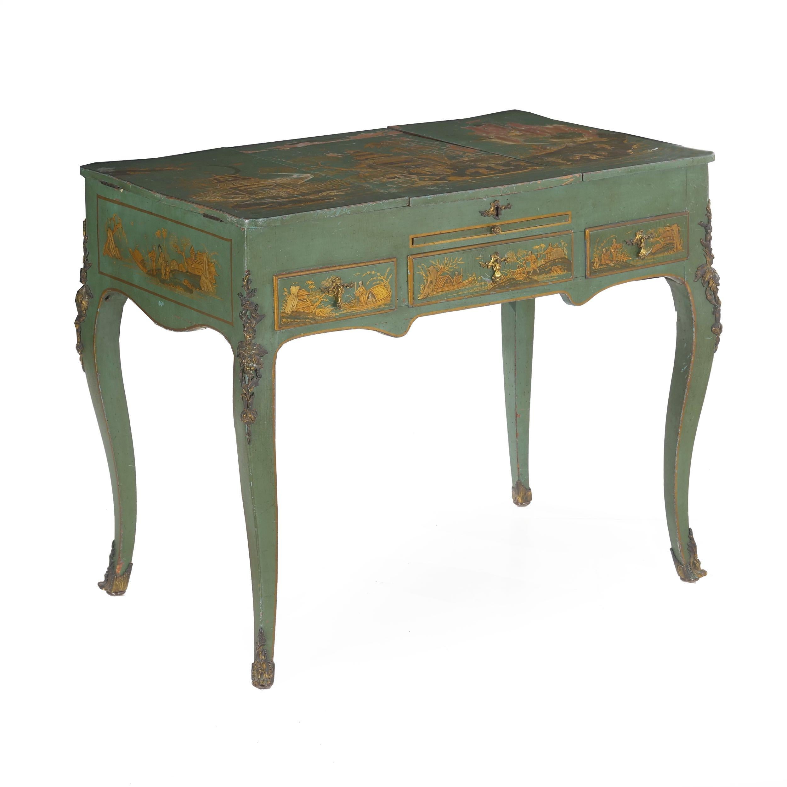 A very attractive dressing table in the Louis XV taste from the turn of the century, the table is decorated in a chinoiserie relief over a green overall ground. It features a variety of Eastern scenes, the apron centered around the role of a single