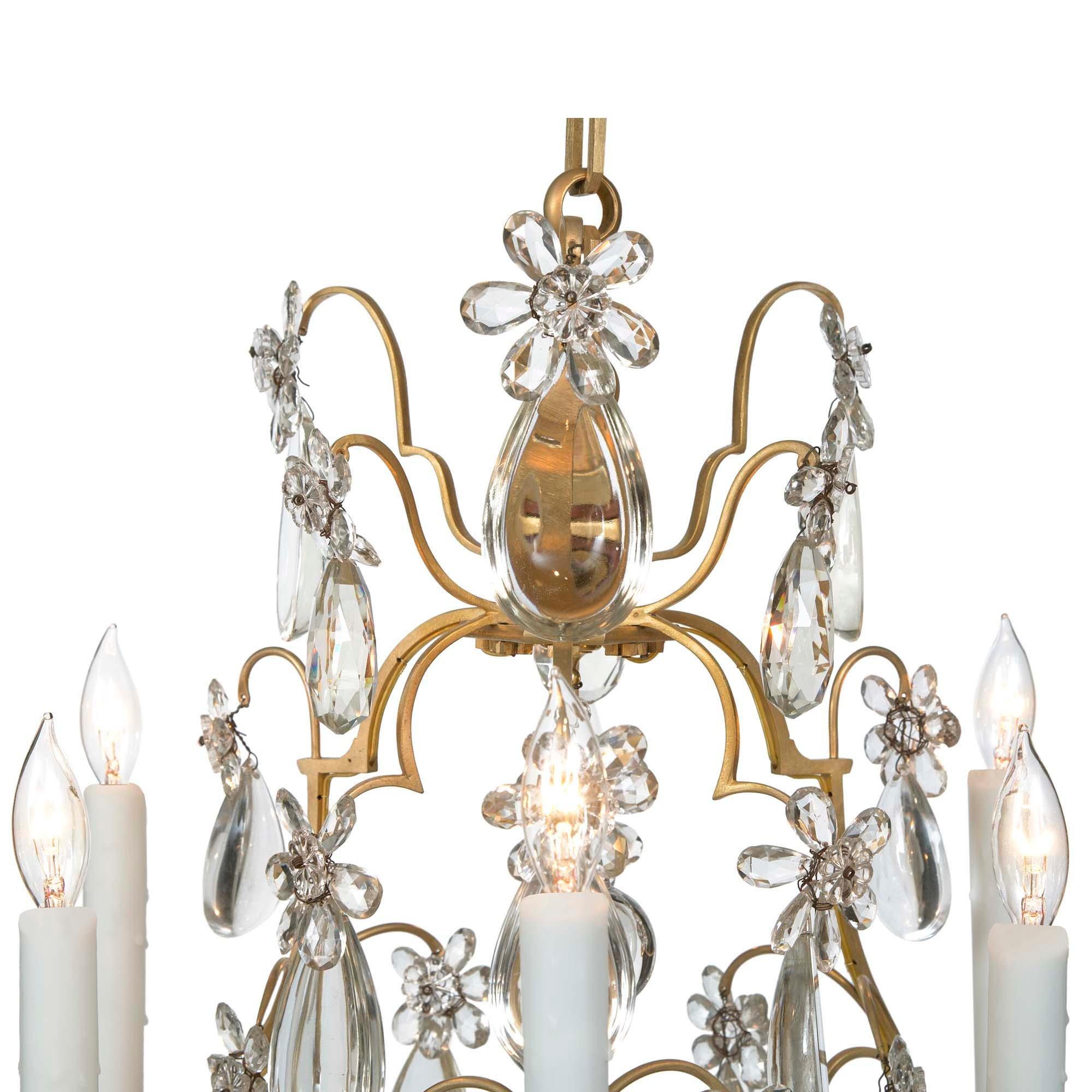 An elegant French 19th Louis XV st. Baccarat crystal and ormolu six light chandelier. The chandelier is centered by a bottom solid crystal ball pendant amidst fine cut and tear drop shaped crystal pendants. each wonderfully scrolled arm is adorned