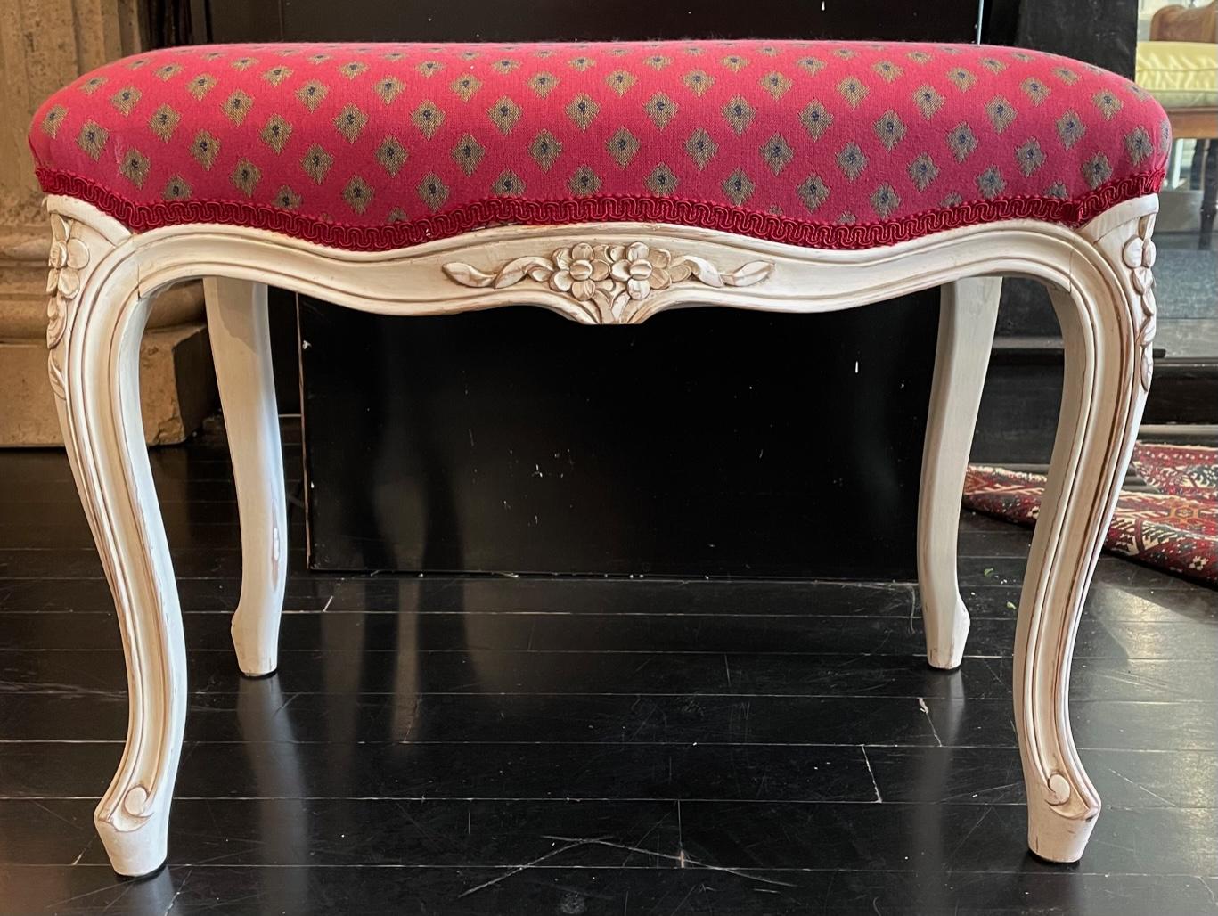 Cette banquette française de style Louis XV est recouverte d'un revêtement rouge framboise vif, créant ainsi une touche de couleur parfaite dans un espace de vie ou une chambre à coucher. Les pieds et les côtés du banc sont magnifiquement sculptés