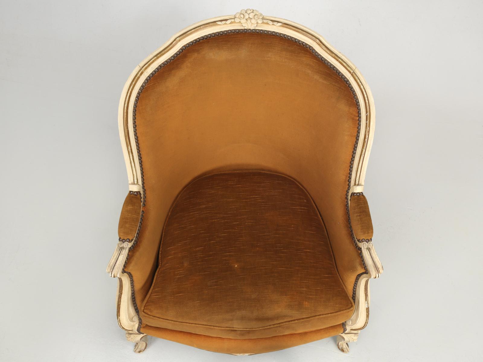 Vintage French Louis XV style Bergère chair in original paint and we believe the original velvet fabric. We are also list an identical pair on 1stdibs. This chair is in as found condition and probably dates for the late 1950s to the early 1960s.