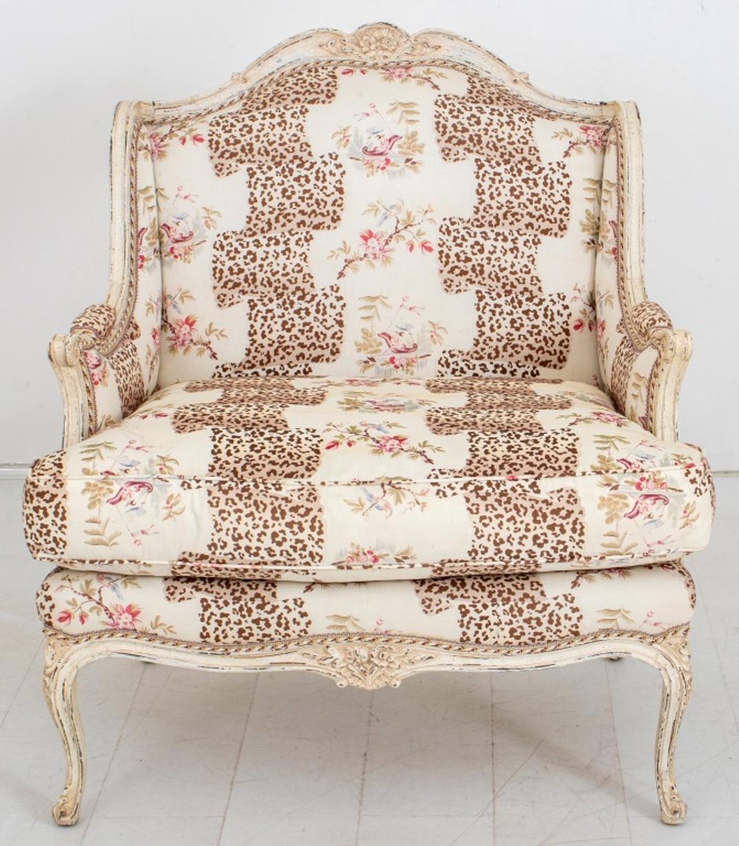 French Louis XV style bergere arm chair and footrest stool, with white painted wood frames and leopard print upholstery.

Dimensions for Chair: 39.5