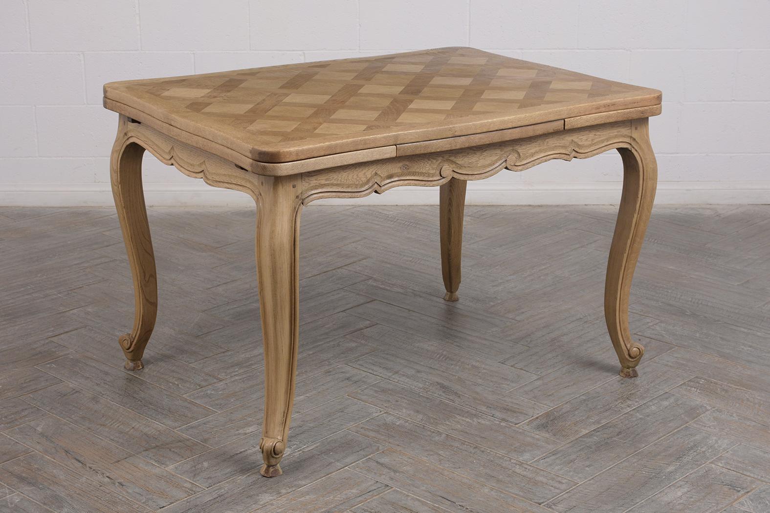 This Early 1880’s French Louis XV Style Marquetry Dining Table is made out of walnut wood and has been bleached & waxed developing a unique finish. This dining table features a marquetry tabletop design with scroll carved legs and comes with