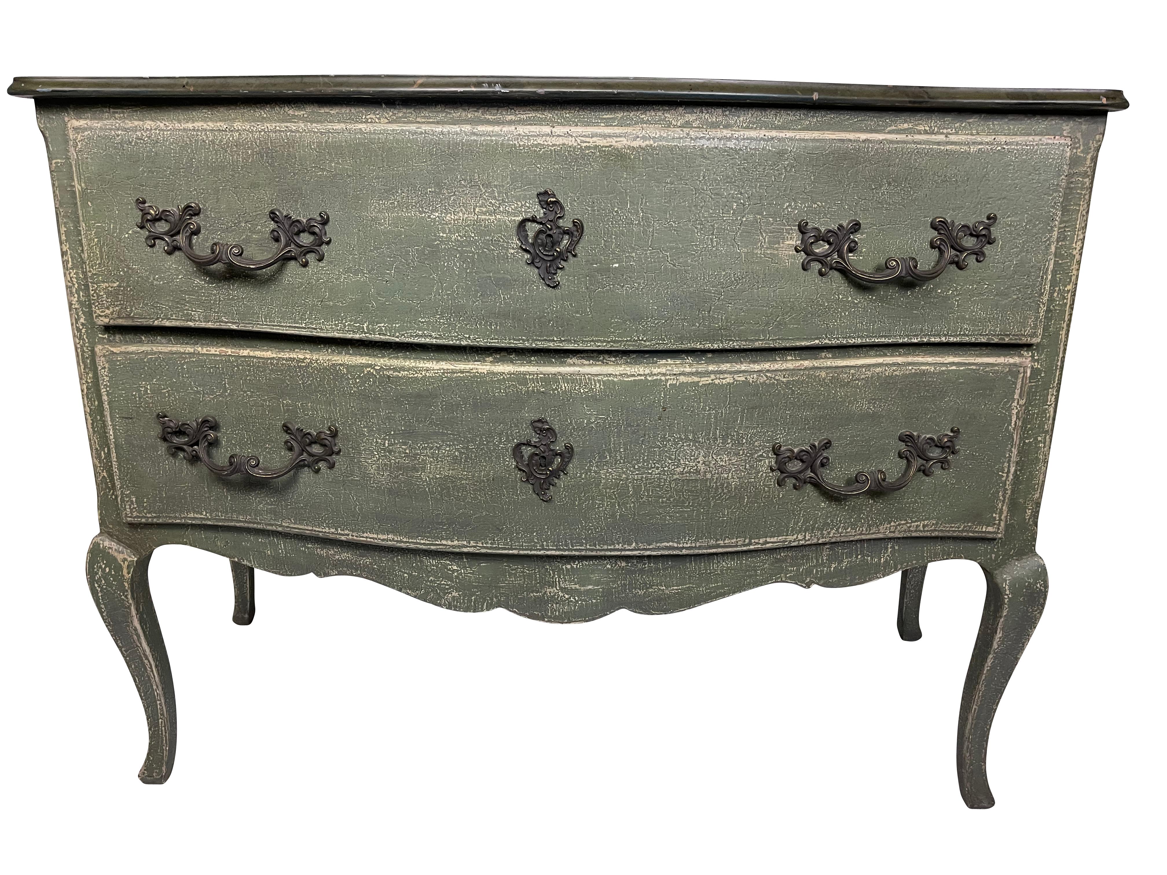 French Louis XV style two drawer blue/green crackle painted two drawer bureau. Fancy metal pulls and key holes. Graceful turned legs. Measures 49 X 34 X 22.