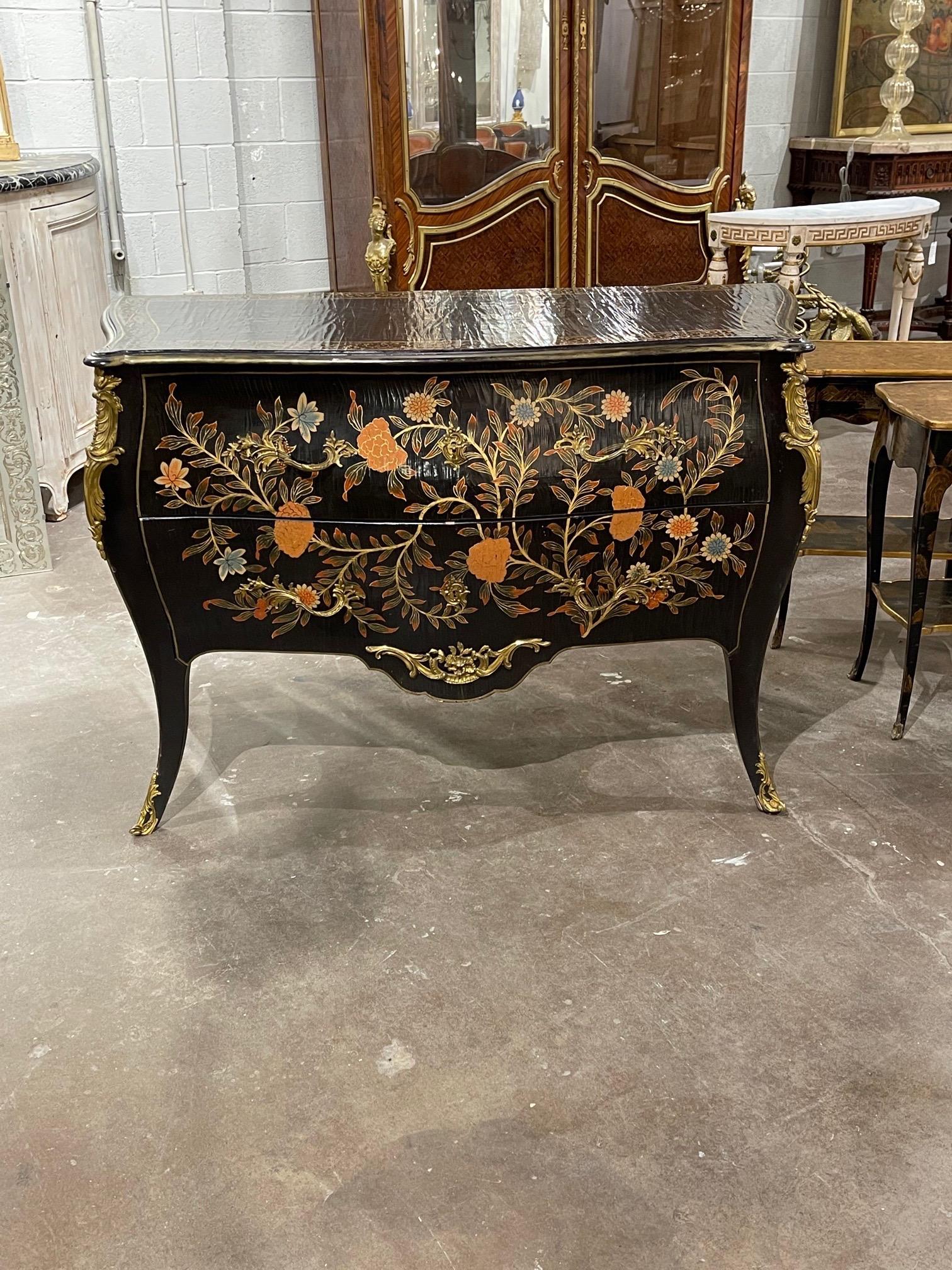 Exquisite French Louis XV style bombe hand painted commode. The piece is painted in a black lacquer along with a beautiful floral design. An amazing work of art!