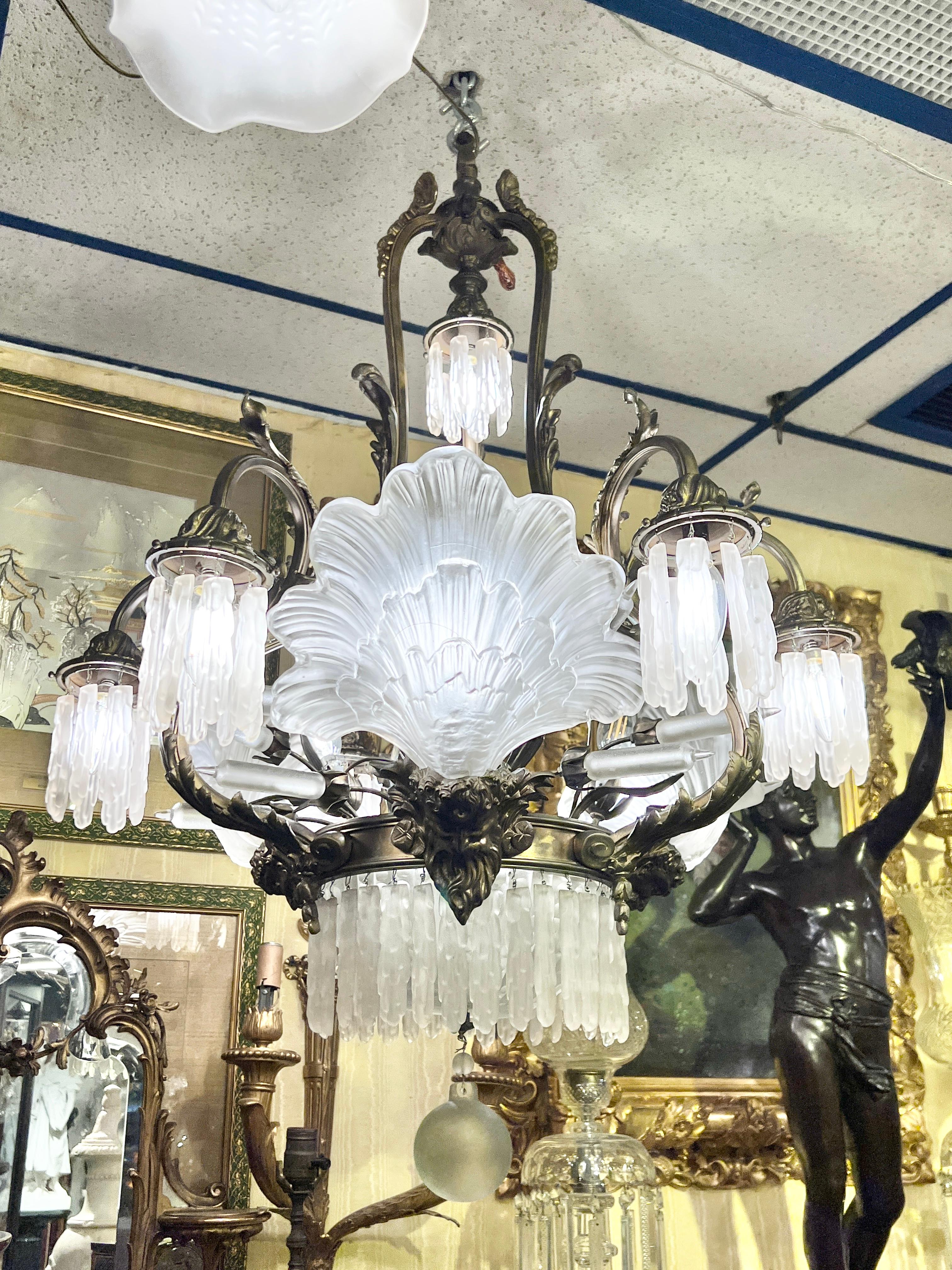 Very fine and unusual Antique bronze chandelier in the Greco-Roman neoclassical /Louis XV style distinguished by its frosted glass elements including downward facing bowl, spherical drop, icicle-form pendants, large seashell-form shades and bull