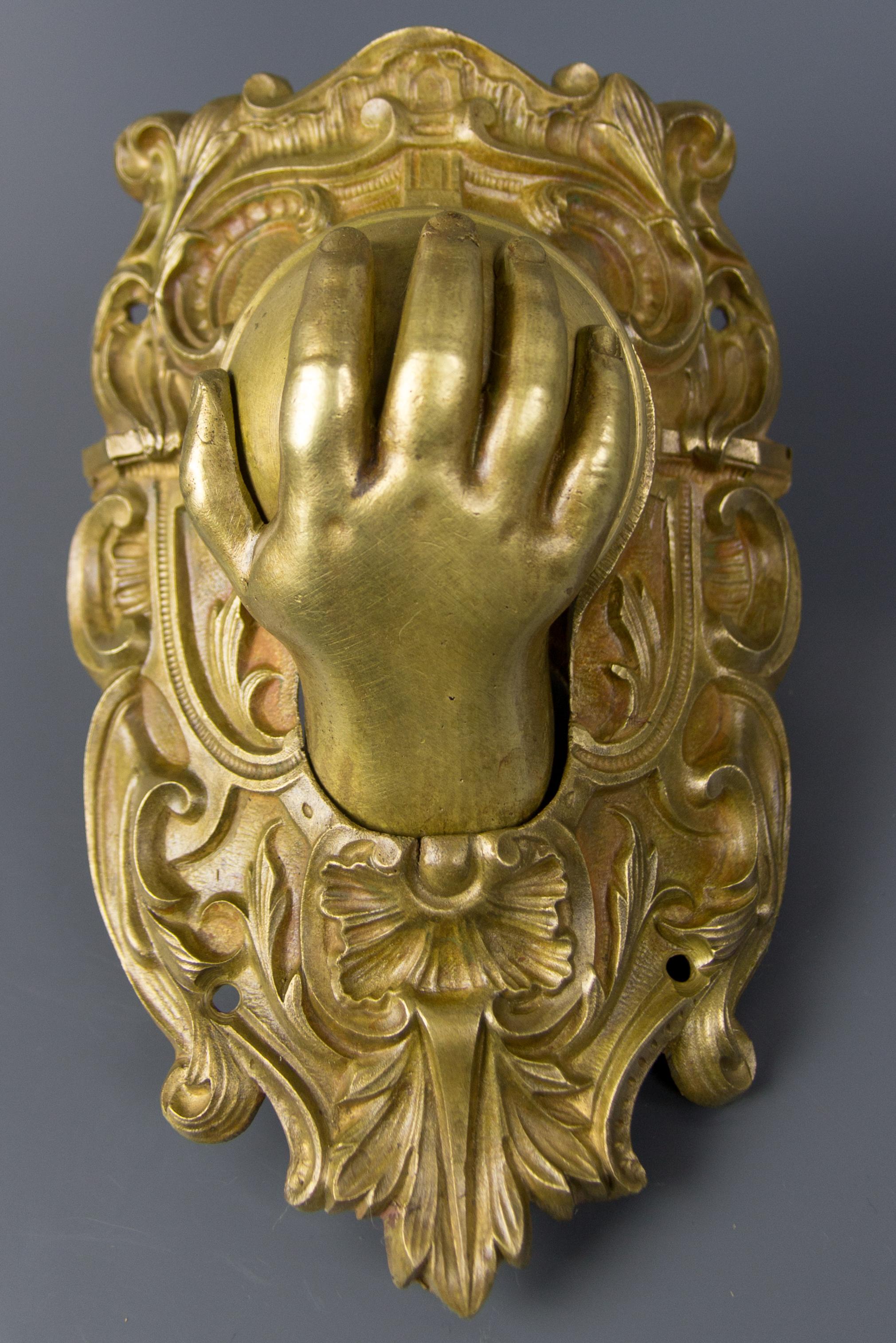 Antique Ornate French bronze billiard corner pocket ball catcher with a baby hand from the late 19th century. It was originally part of the ornate decoration of a large billiard table and would have been positioned on one of the corner pockets. The