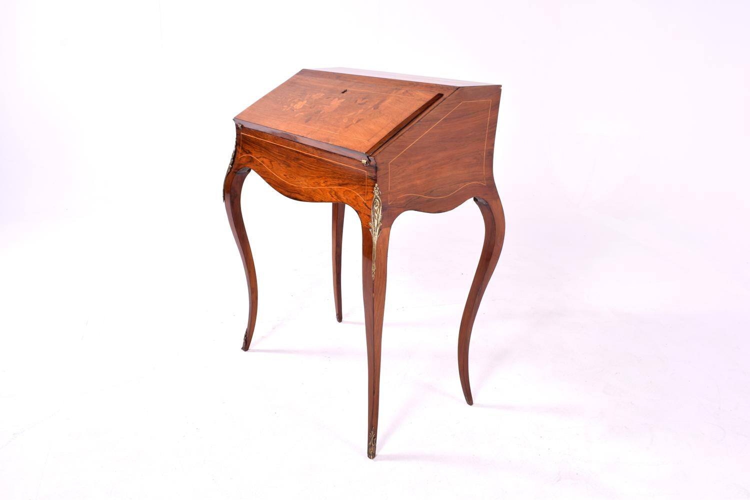 Bureau desk with fine gilt ormolu mounts and veneers in king wood, satinwood and rosewood. The ornate marquetry surface adorned with gilt bronze ormolu. French Rococo style this gorgeous desk is more likely made in England in the mid-19th century