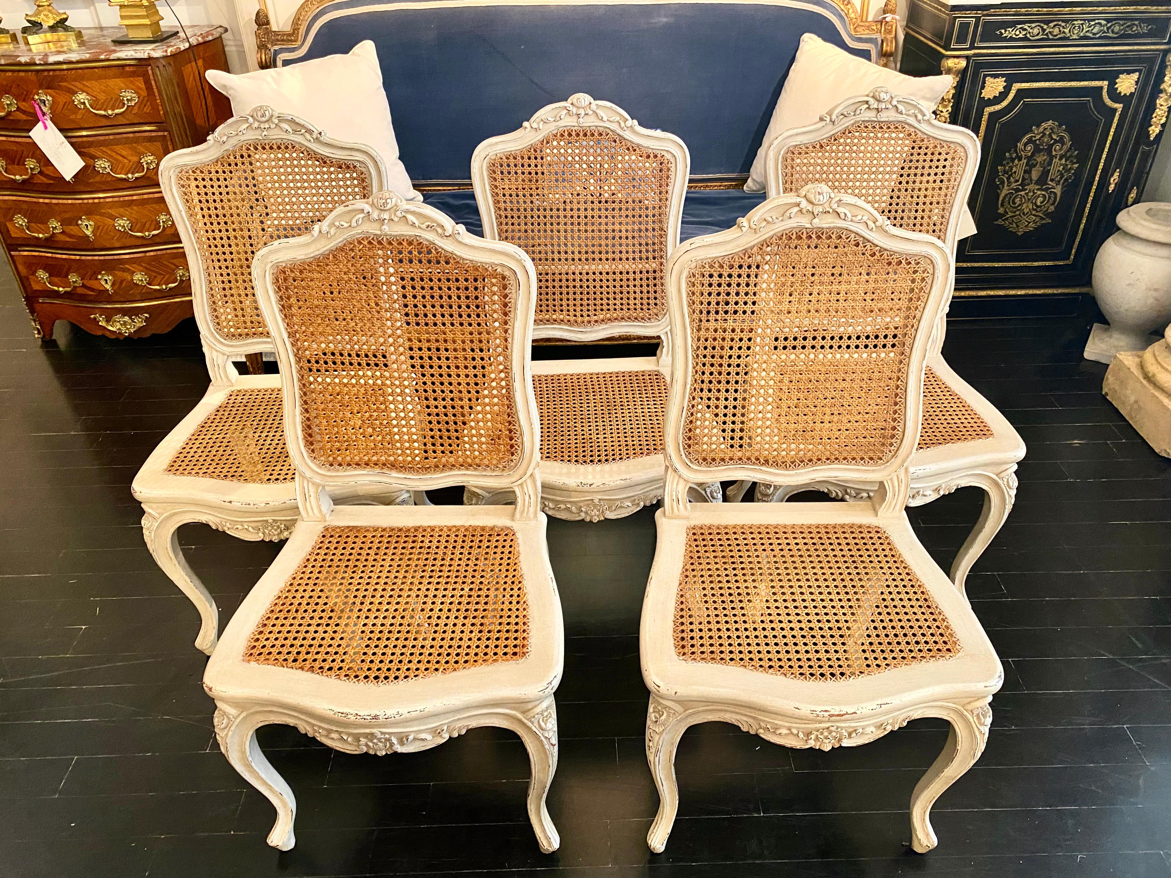 Set of six French pale Trianon grey patinated chairs with natural caned backs and seats, in the classic style of Louis XV.

 Mid-Century Modern, Hollywood Regency style.
 