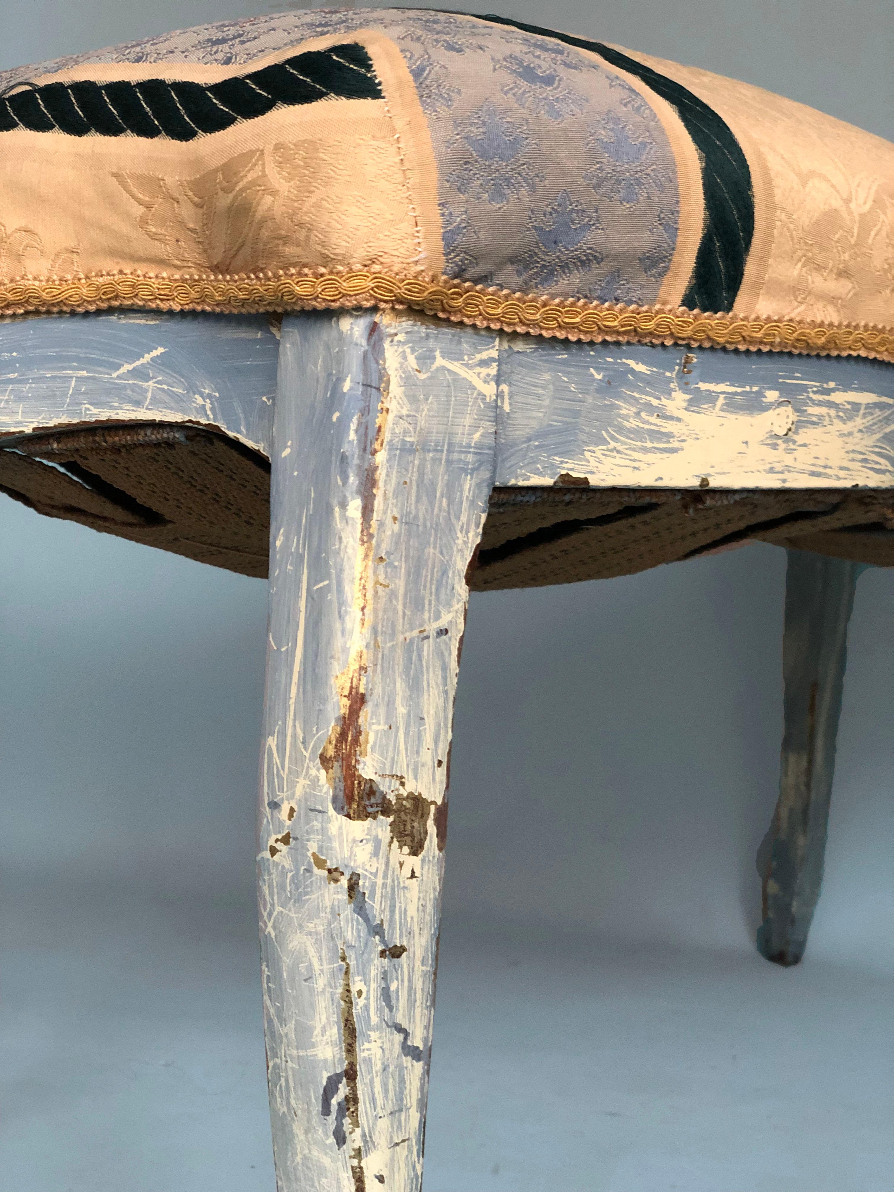 A very detailed walnut bench in Louis XV style late 19th century. The bench is nicely weathered. The legs were painted light blue a long time ago. The seat has the original springs and the detailed fabric is from a later period. Very soft to sit