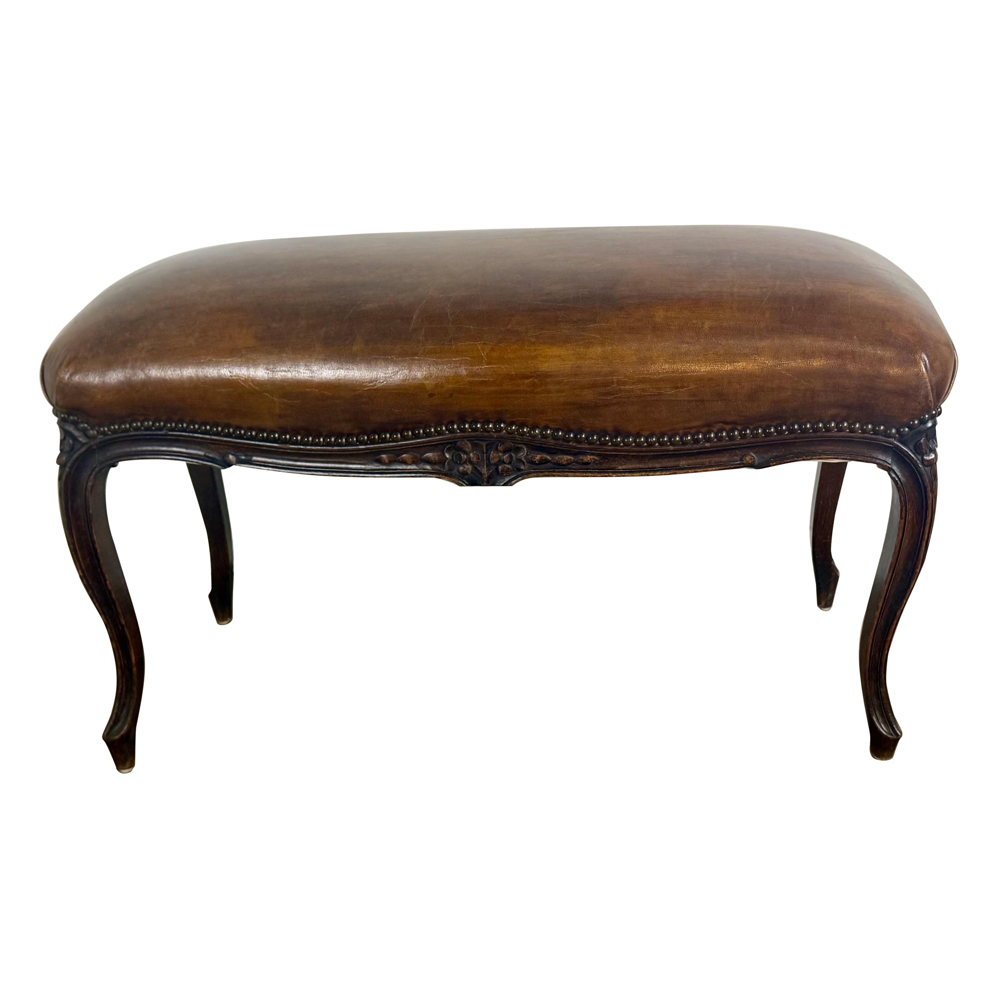 French Louis XV Style Carved Bench with Distressed Leather Upholstery
